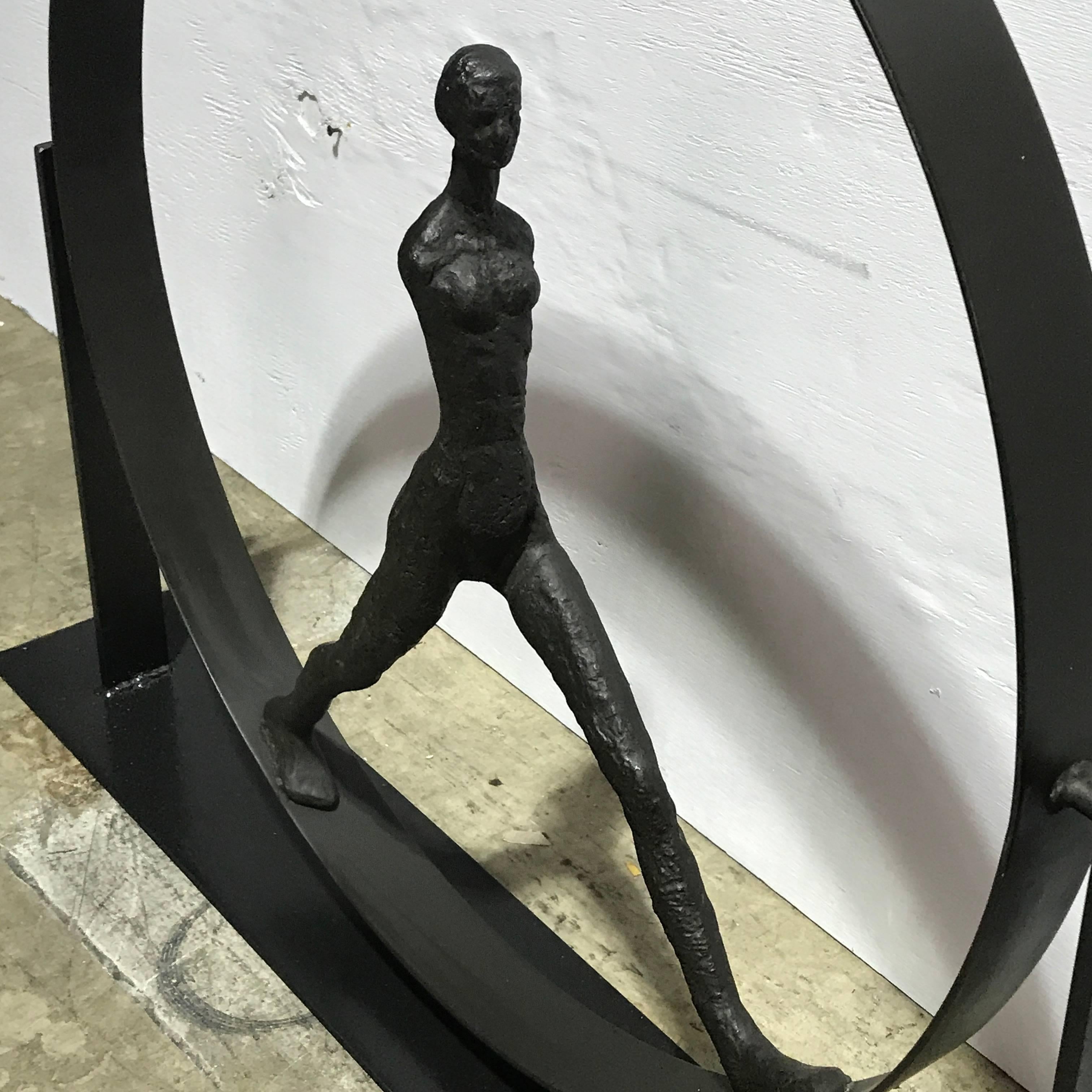 After Giacometti walking figure in sphere, large-scale, well sculpted bronze walking figure in a 29.5