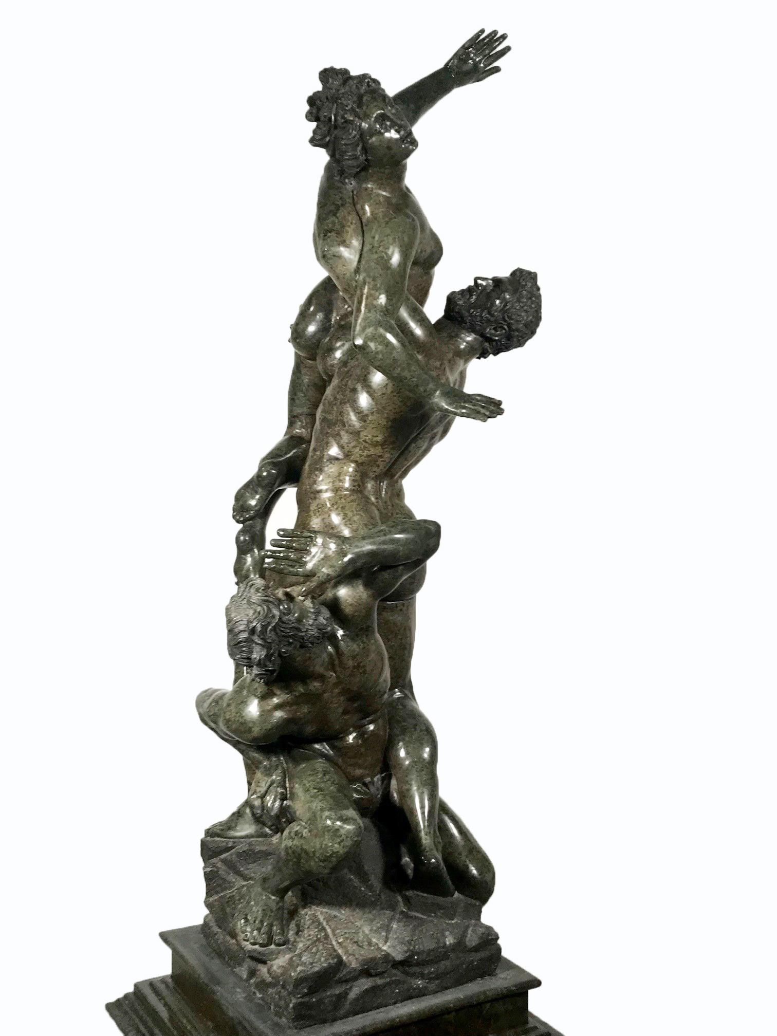 This fine 19th century copy of the famous group is in a sumptuous Serpentine marble. The Sabine man crouches in submissive pose, whilst the Roman carries off the writhing woman. It is well-presented on the original matching plinth and pedestal .