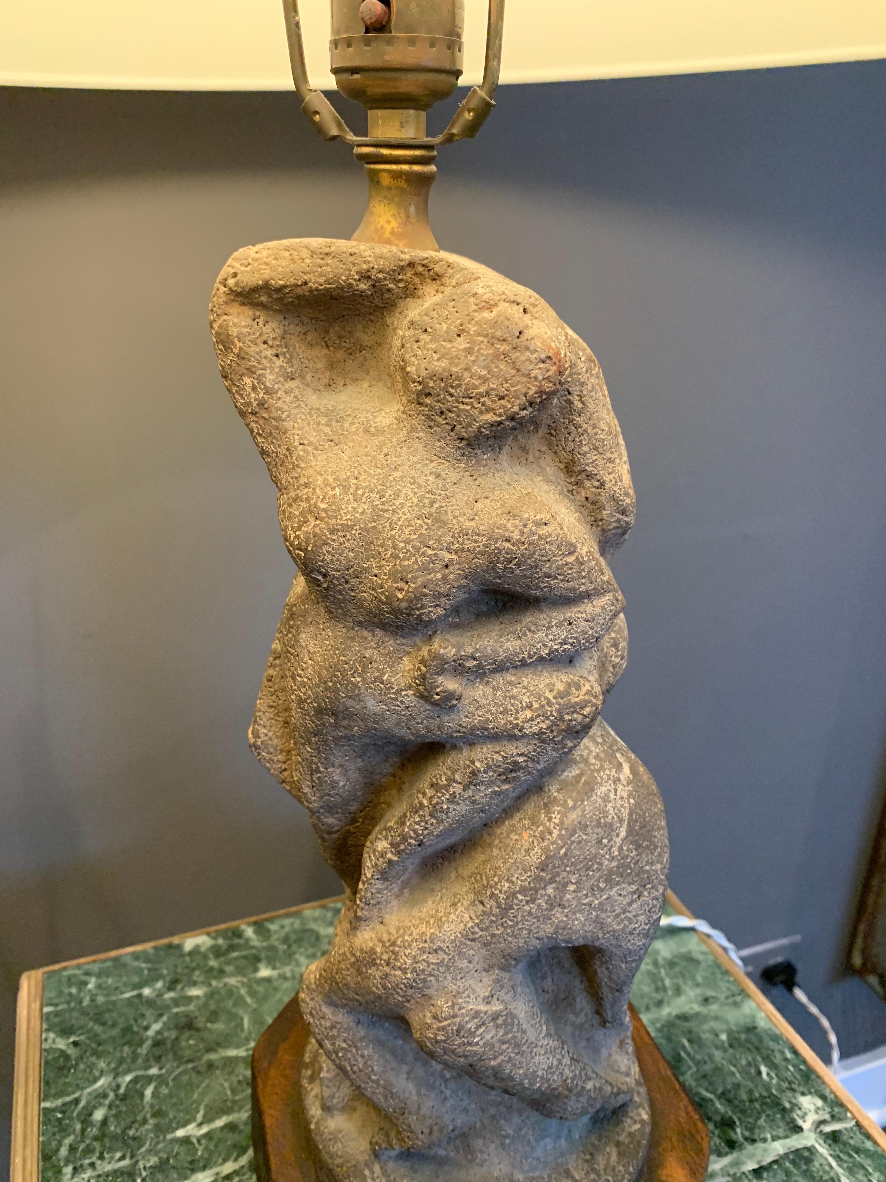 A gorgeous vintage sculptural carved stone lamp on a wooden base in the style of Henry Moore. Depicting multiple dancing abstract figures. Beautiful patina. Newly rewired with silk cable in perfect working condition. Shade not included, for display