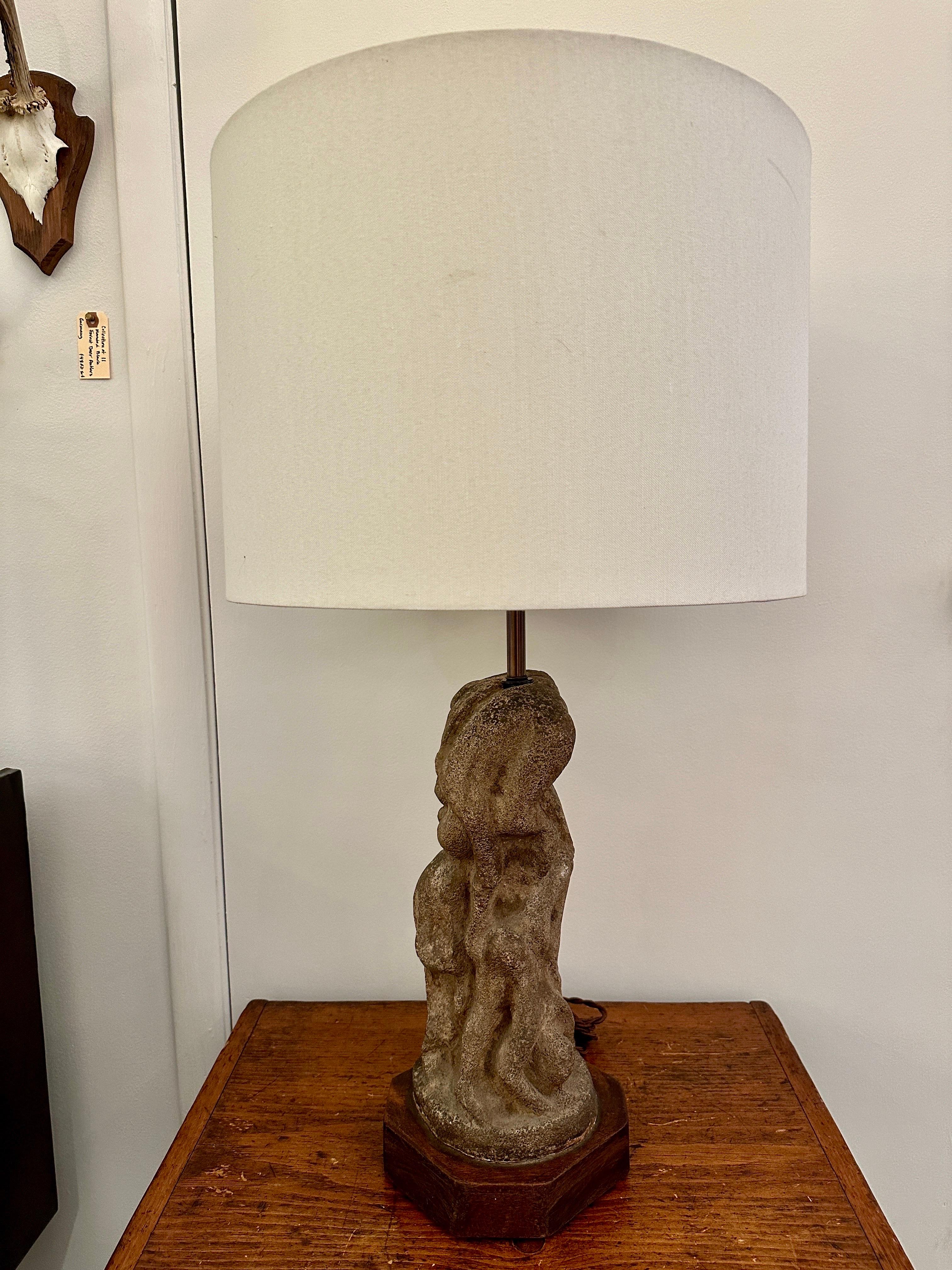 A gorgeous vintage sculptural carved stone lamp on a wooden base in the style of Henry Moore. Depicting multiple dancing abstract figures. Beautiful patina. Shade not included, for display only. Measures: Height of sculpture is 16