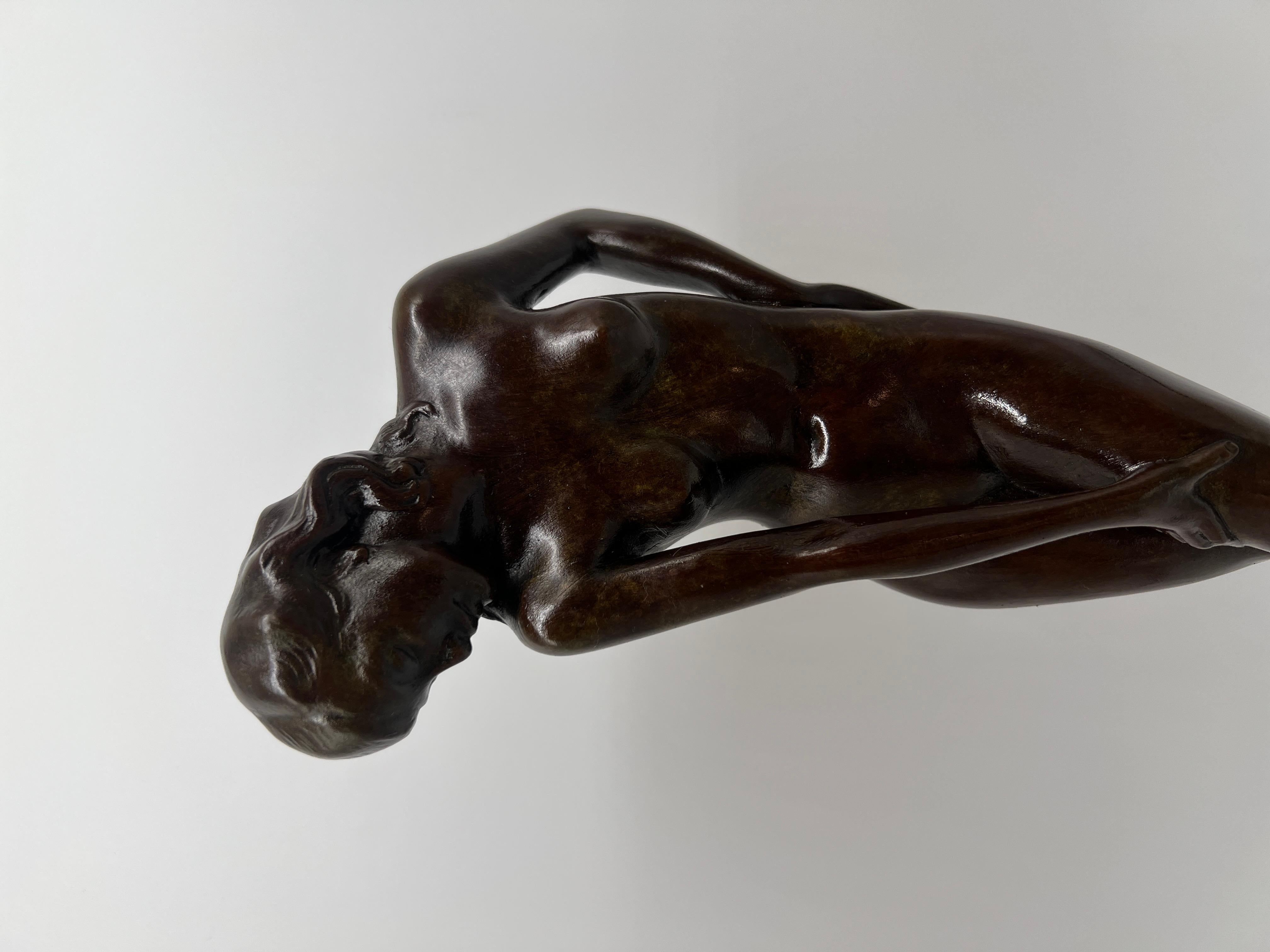 This elegant bronzed statue, titled 
