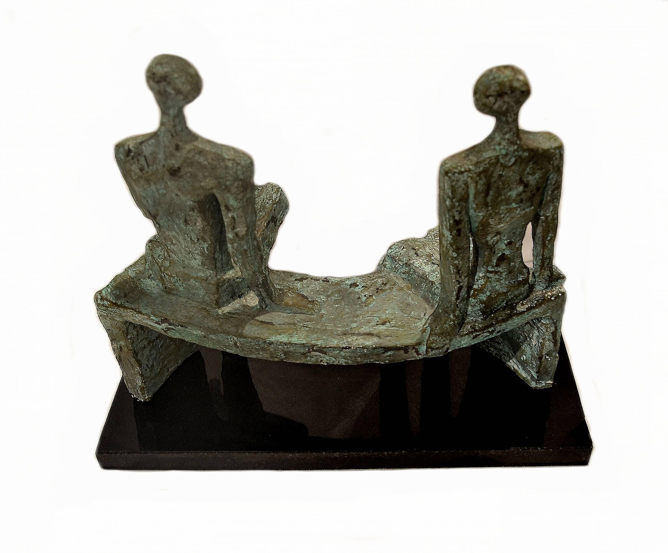 Exceptional vintage bronze sculpture after Henry Moore. Featuring two figures seated on a bench and mounted on a black marble base.
 