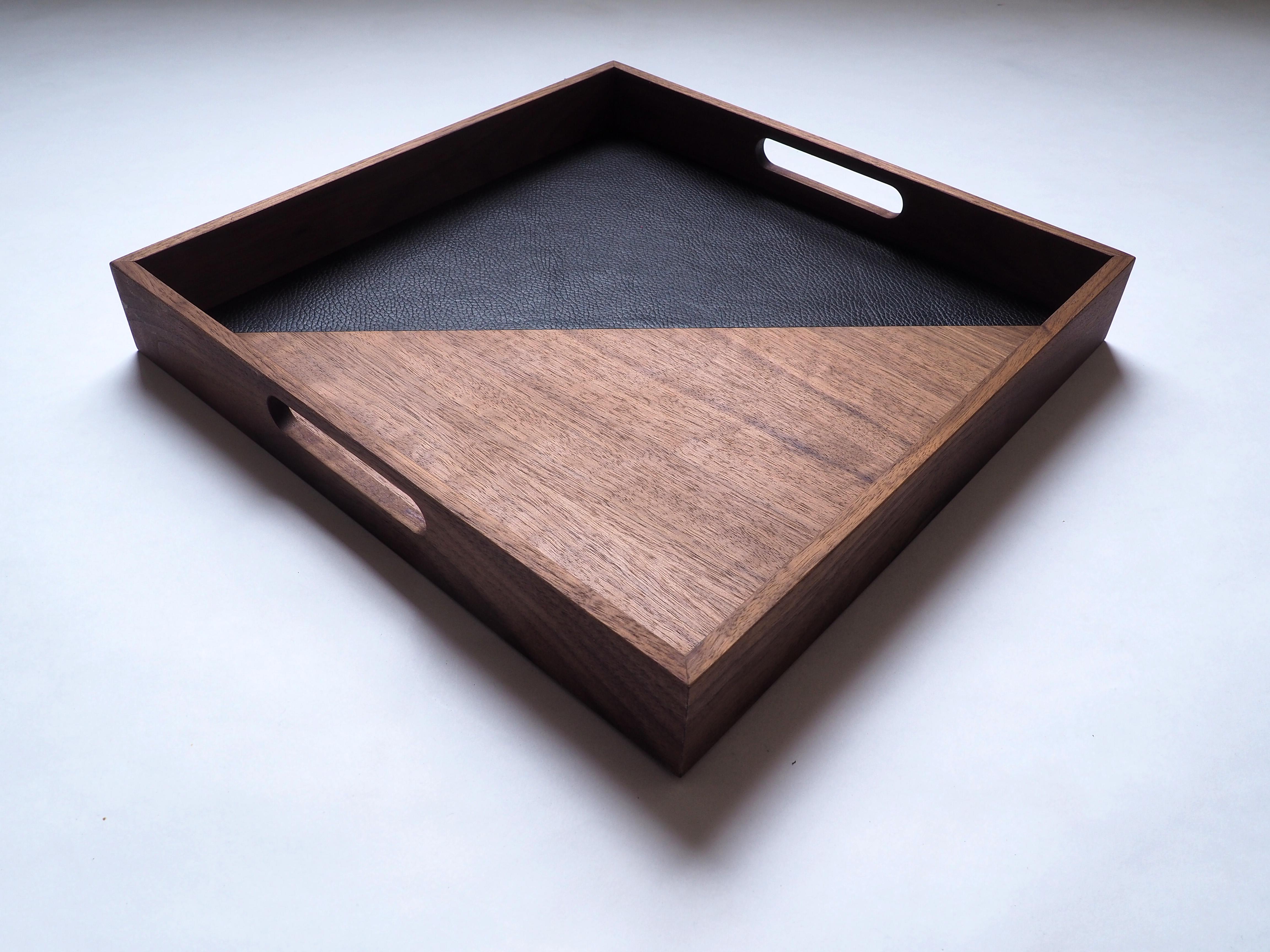 Handcrafted serving tray in walnut wood and black buffalo leather.  
It can be used both to serve tea and to display beautiful books on a coffee table. 
A must-have !

The junction between leather and wood is flush and invisible.
The blend of wood