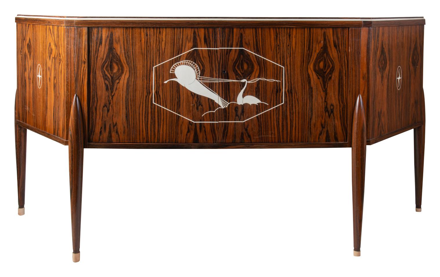 A wonderful quality Art deco style side cabinet, after Jacques-Emile Ruhlmann, having dramatic veneers with classical inlaid decoration, two central opening doors and raised on turned tapering legs.
Ref; File:J.-E. Ruhlmann au Musée des Années 30