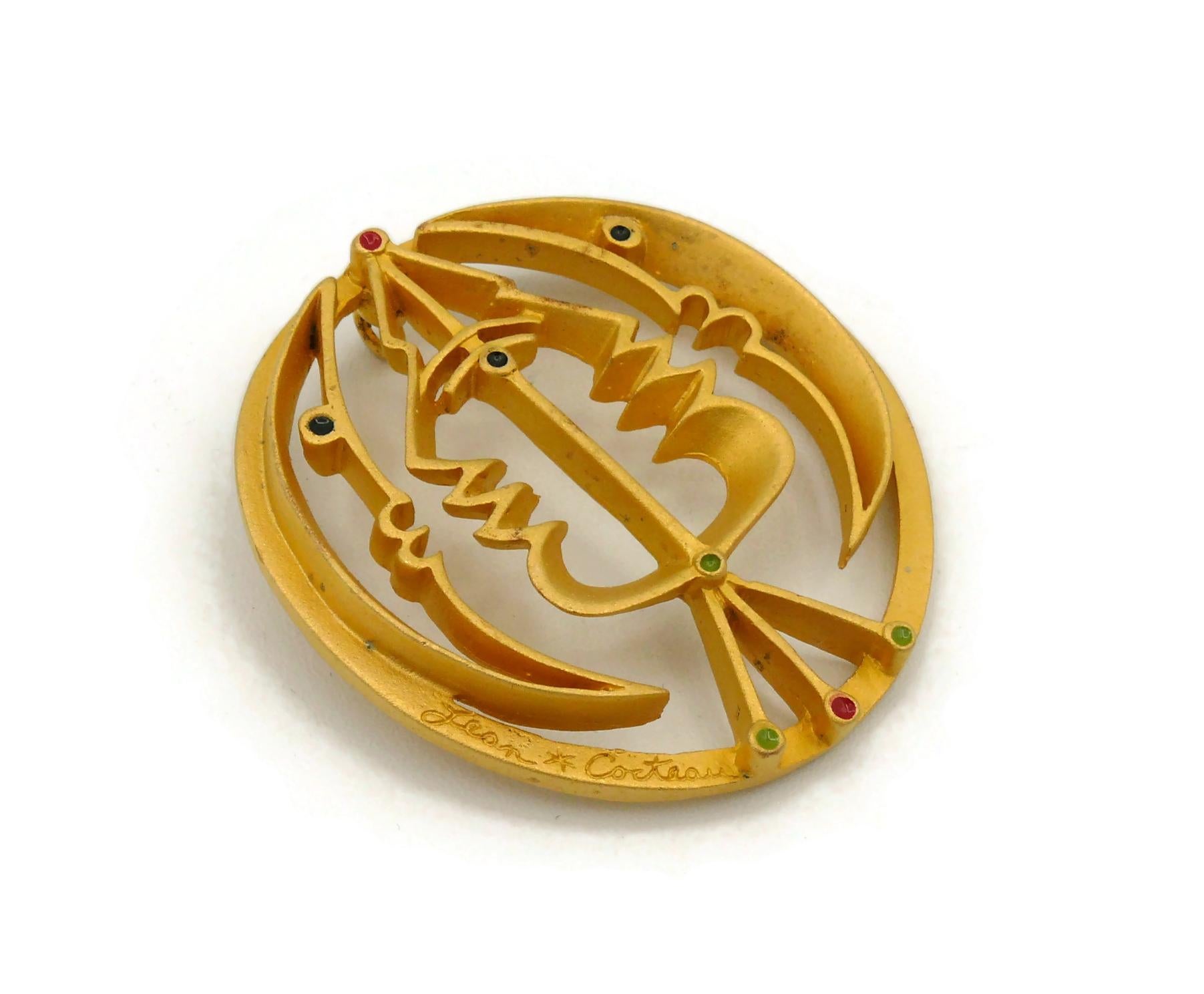 After JEAN COCTEAU moon and profile sculpture pendant edited by MADELINE FLAMMARION.

This pendant is matte gold toned with multi colored enamel details featuring abstract profiles and crescent moon.

Signed JEAN COCTEAU.
Embossed COMITE JEAN