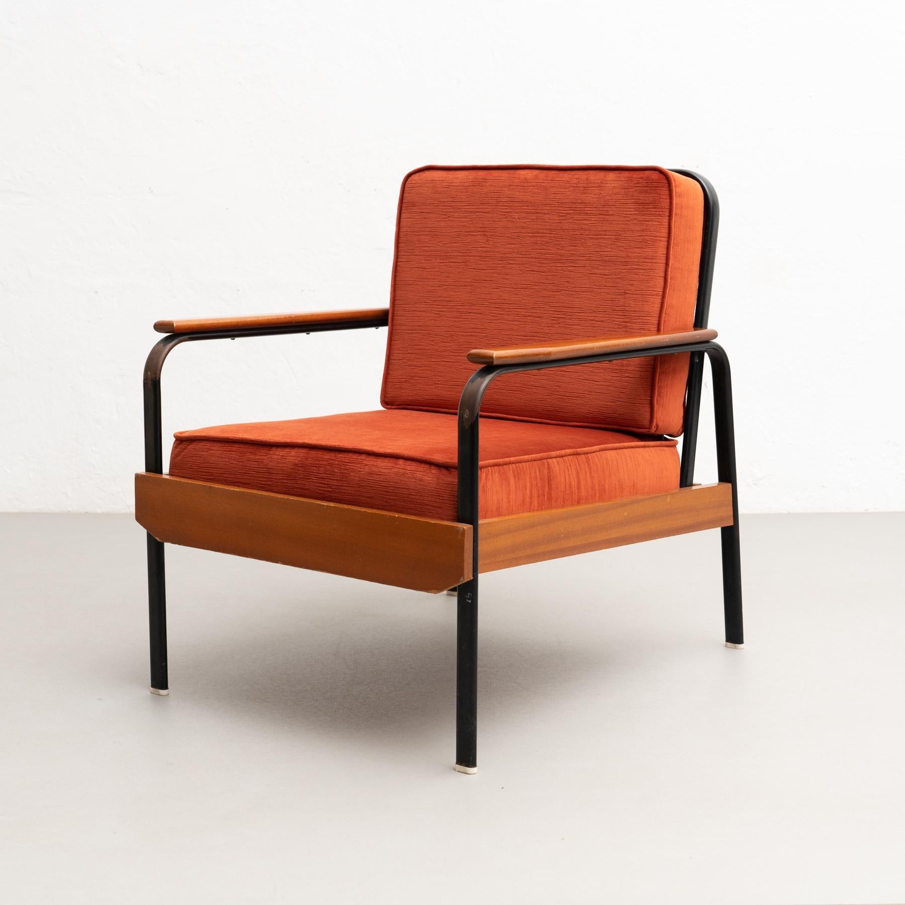 Easy chair by unknown manufacturer in France circa 1950, designed in the style of Jean Prouve.    Lacquered metal base and wood.     In original condition, with minor wear consistent with age and use, preserving a beautiful patina.    Materials: 