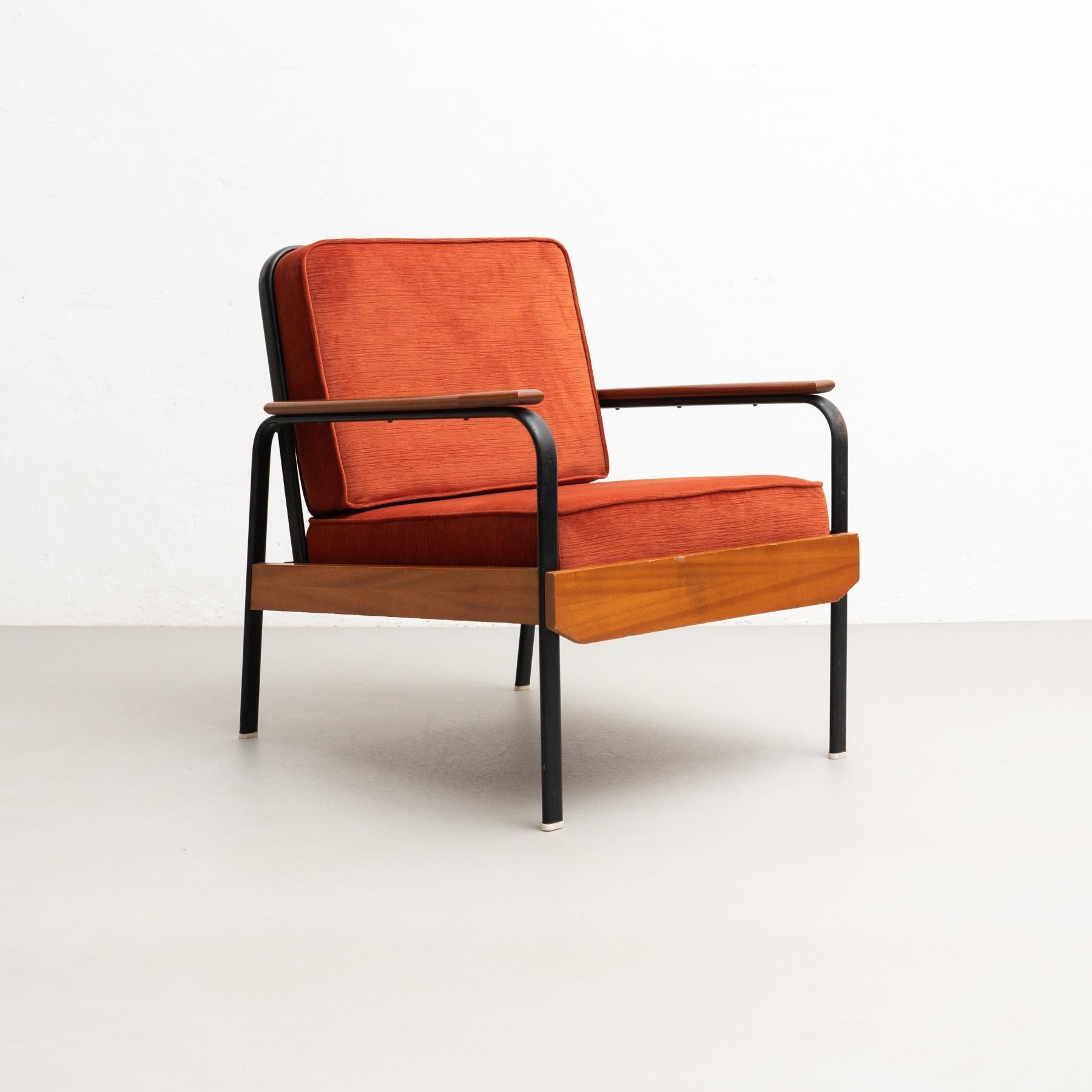 Easy chair by unknown manufacturer in France circa 1950, designed in the style of Jean Prouve.    Lacquered metal base and wood.     In original condition, with minor wear consistent with age and use, preserving a beautiful patina.    Materials: 