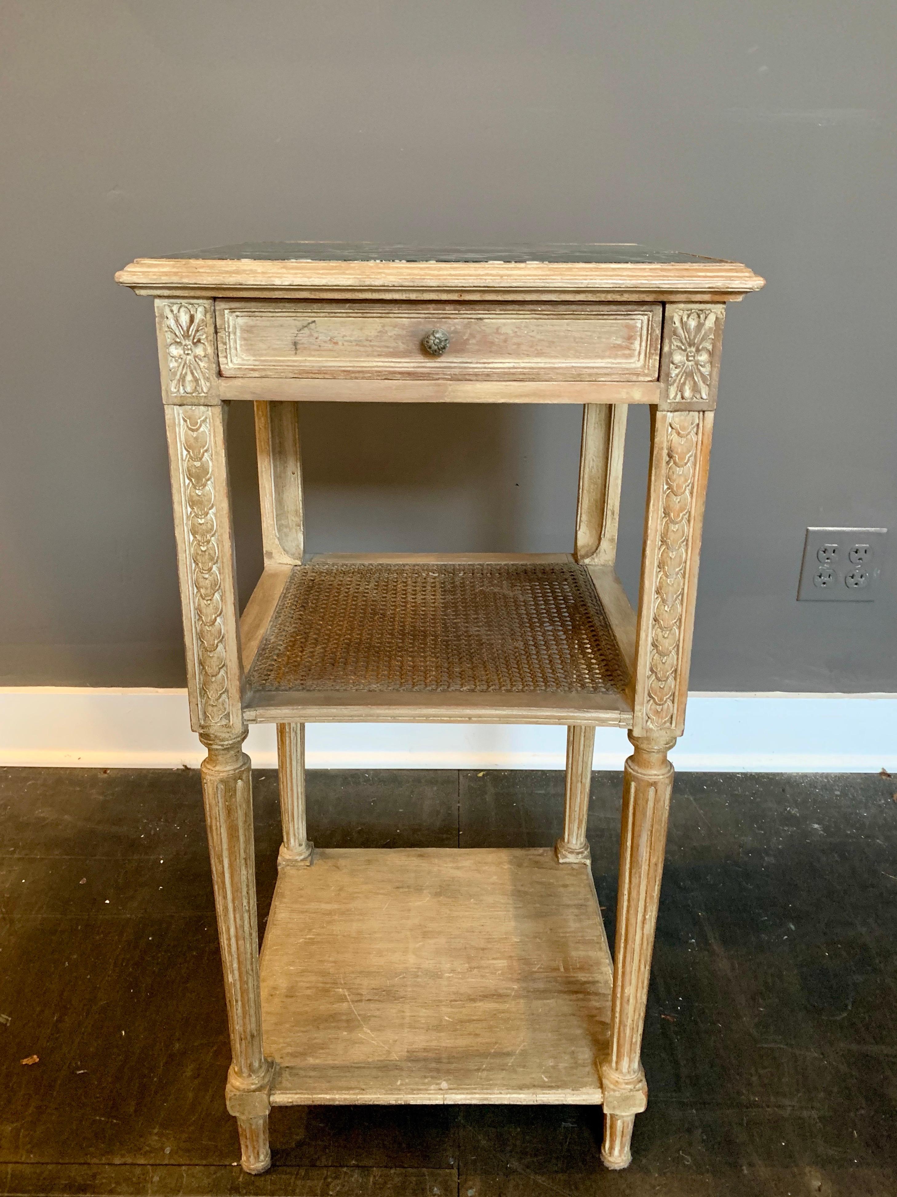French Louis XVI Style. Classic and elegant, this green marble top wash oak side table features 3 levels, single drawer and a woven cane shelf (small hole in back, not too noticeable). Great French style.
