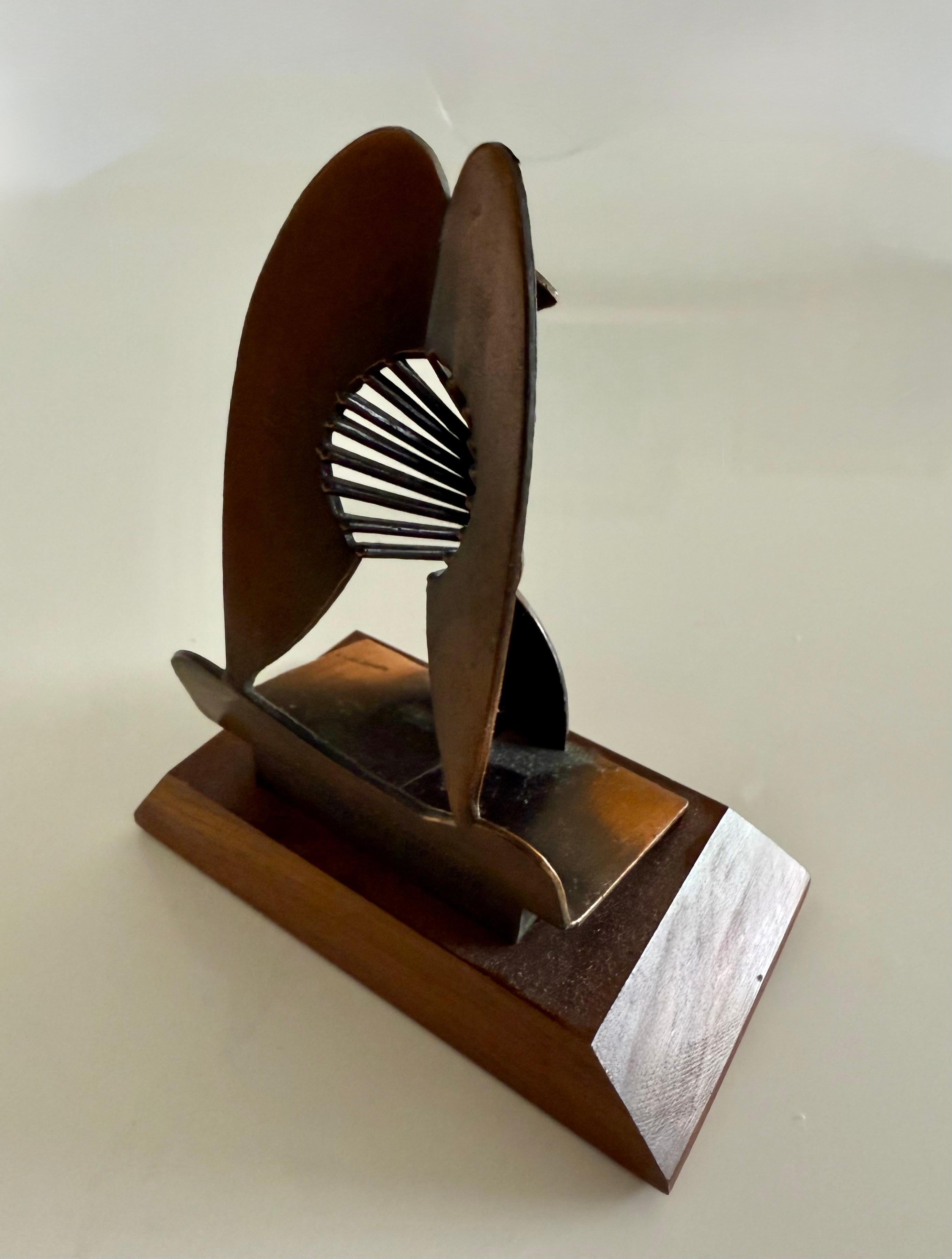 This is a model of the large Picasso sculpture in Chicago it is a vintage piece.  it is marked 1967 and was made for the Chicago Public Building Commission (it is also marked Handiguild inc. 1970)
there is a bronze colored patina to the piece.