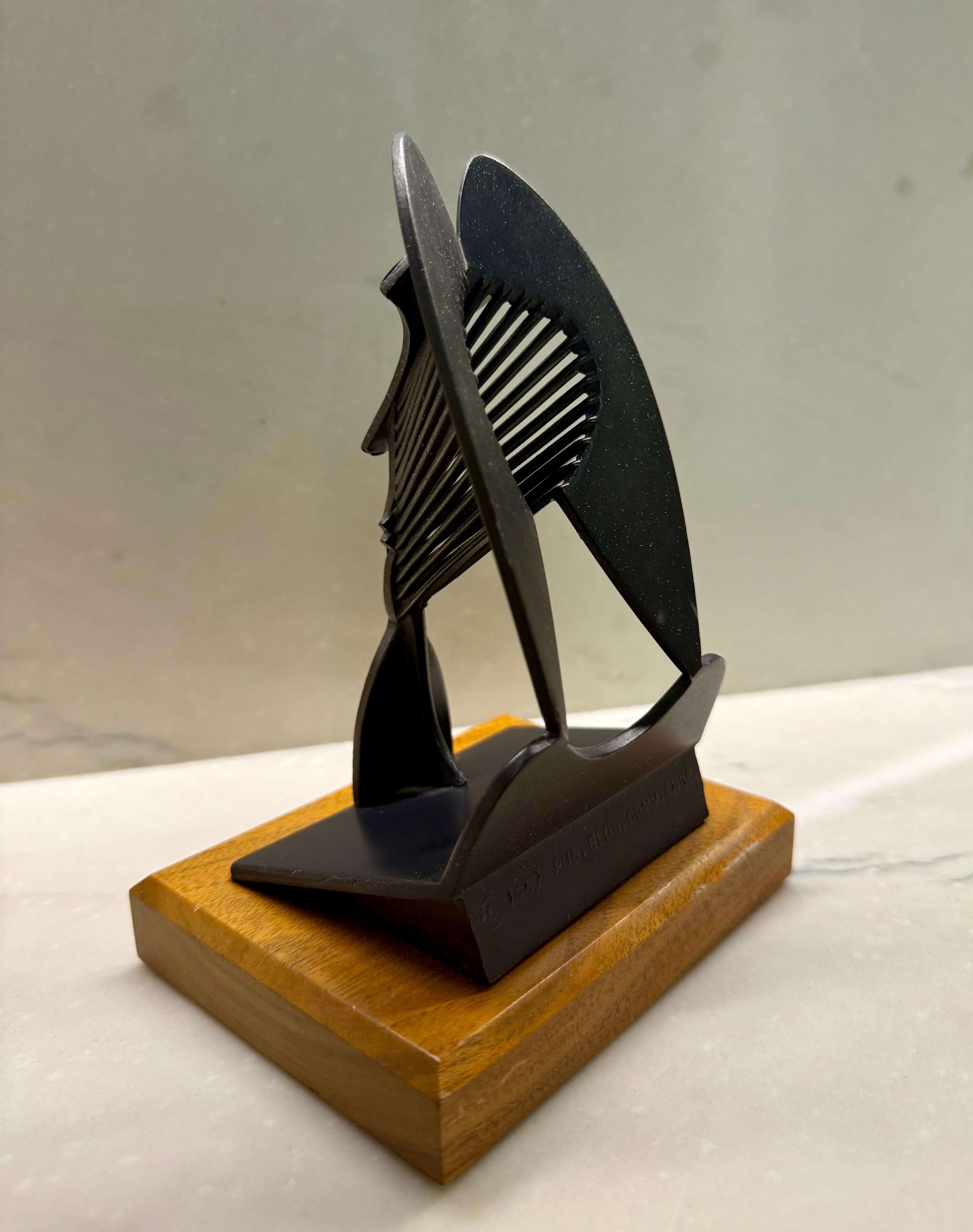 This is a model of the large Picasso sculpture in Chicago it is a vintage piece from 1967 and was made for the Chicago Public Building Commission (I believe by the Chicago replica co.)
there is a bronze colored patina to the piece. Mounted to a wood