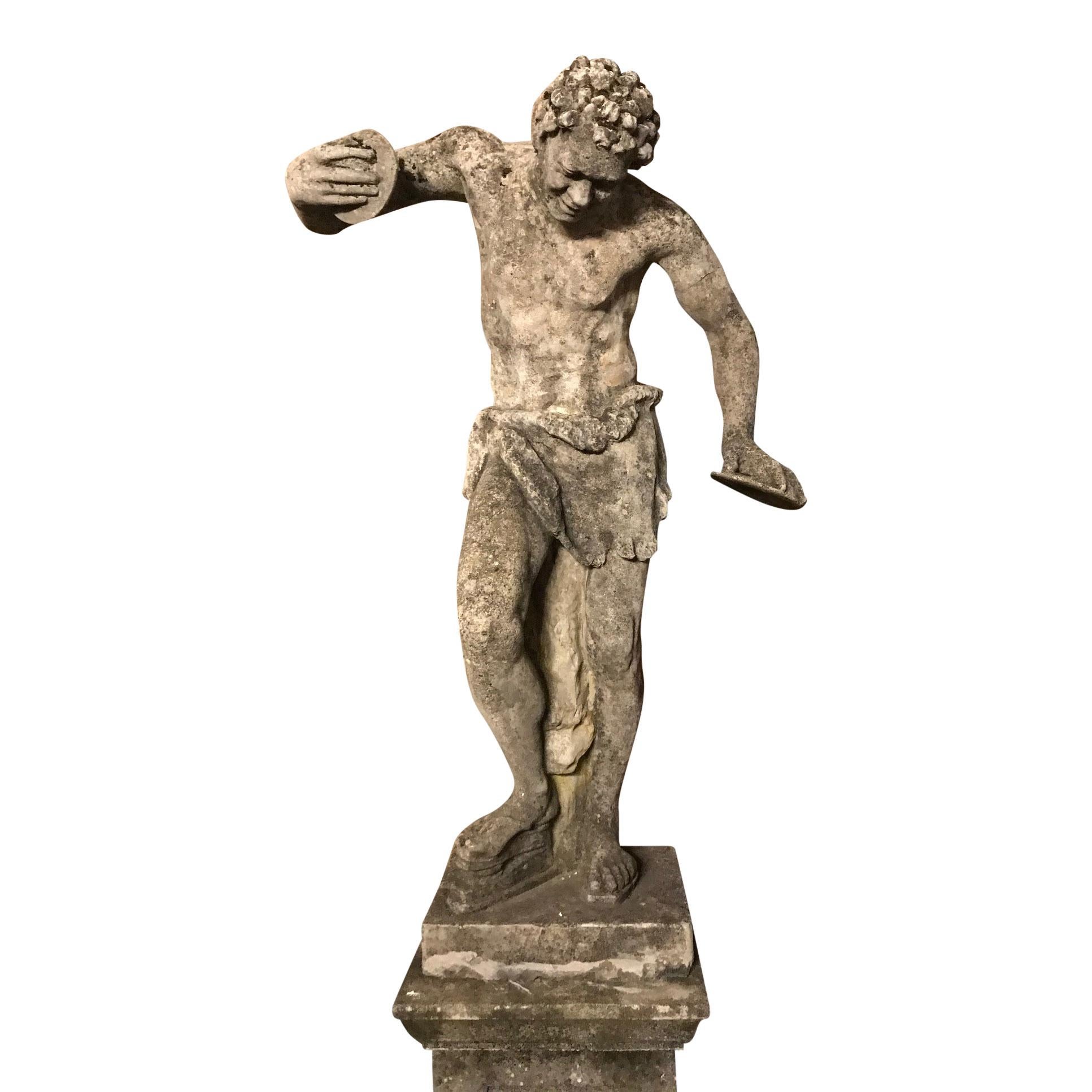AFTER THE ANTIQUE, A LARGE COMPOSITION STONE FIGURE OF THE DANCING FAUN WITH CYMBOLS

20th century 
(Pedestal not included), 100cm wide, 34cm deep, 143cm high (39in wide, 13in deep, 56in high) and the base of the figure: 43cm wide x 34cm deep