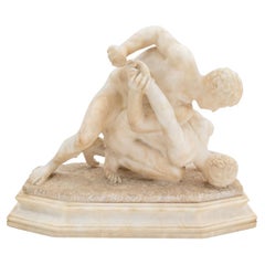 Después de la escultura antigua de piedra de dos luchadores