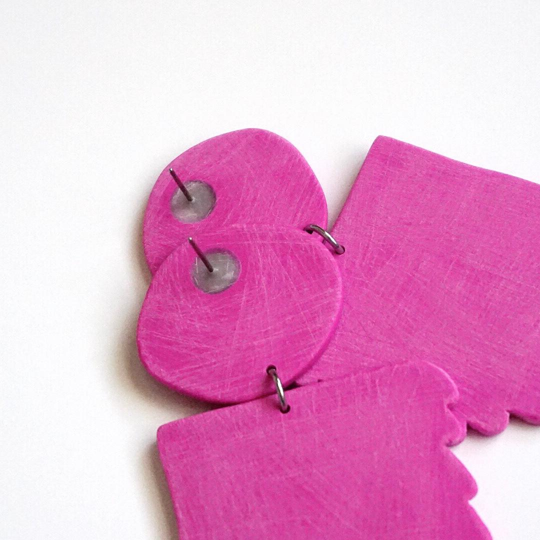 Afterglow Earrings Polymer Clay & Titanium in Magenta by Shape + Form

Hand-cut from a custom cutter and made of ultra lightweight polymer clay. Hand distressed, matte finish. Each component goes through a laborious process that begins with clay and