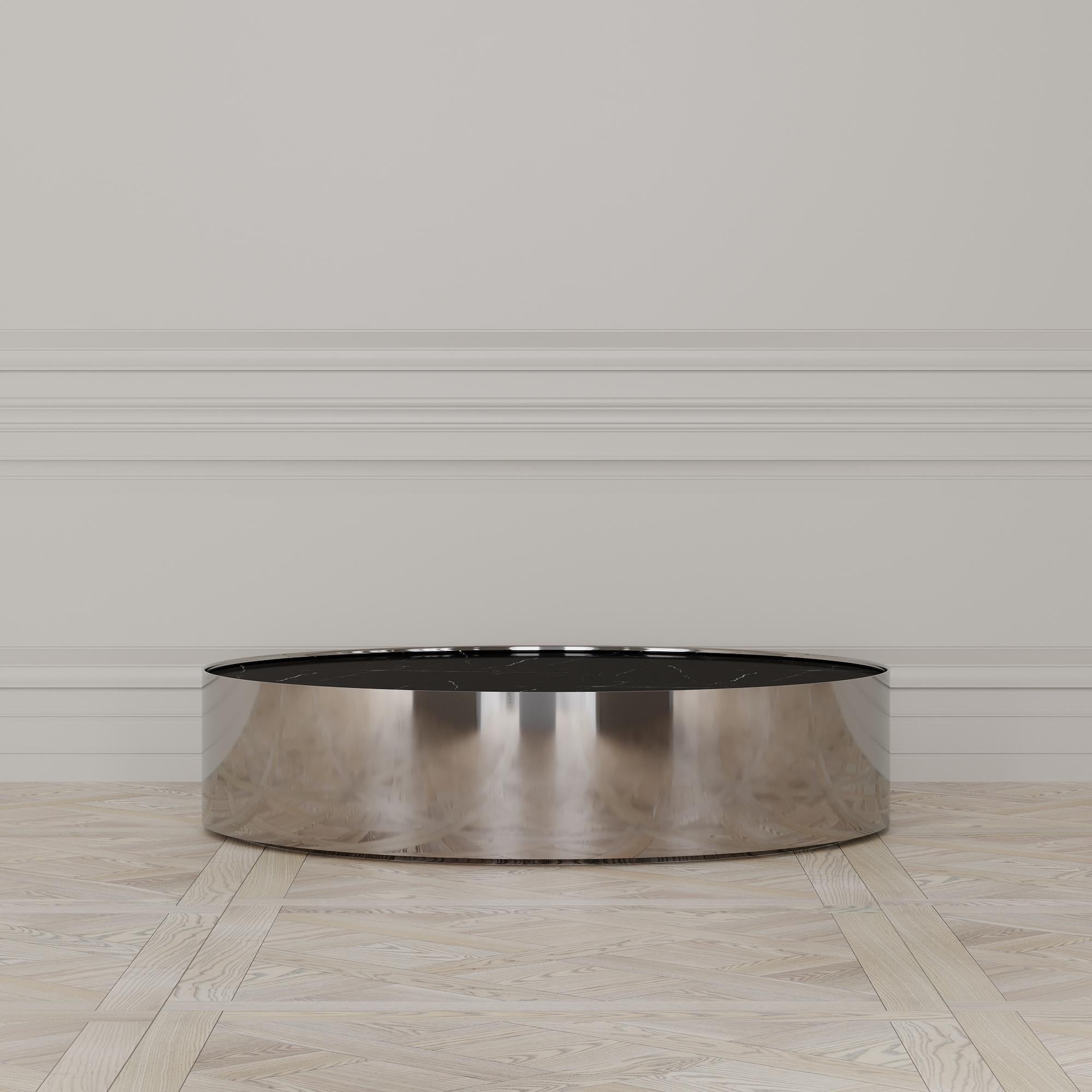 The Afterglow coffee table is designed by Emél & Browne in the Minimalist and contemporary style and custom made in Italy by skilled artisans.

The circular Nero Marquina marble top evokes the certainty of the coming night, and acts as a back-drop