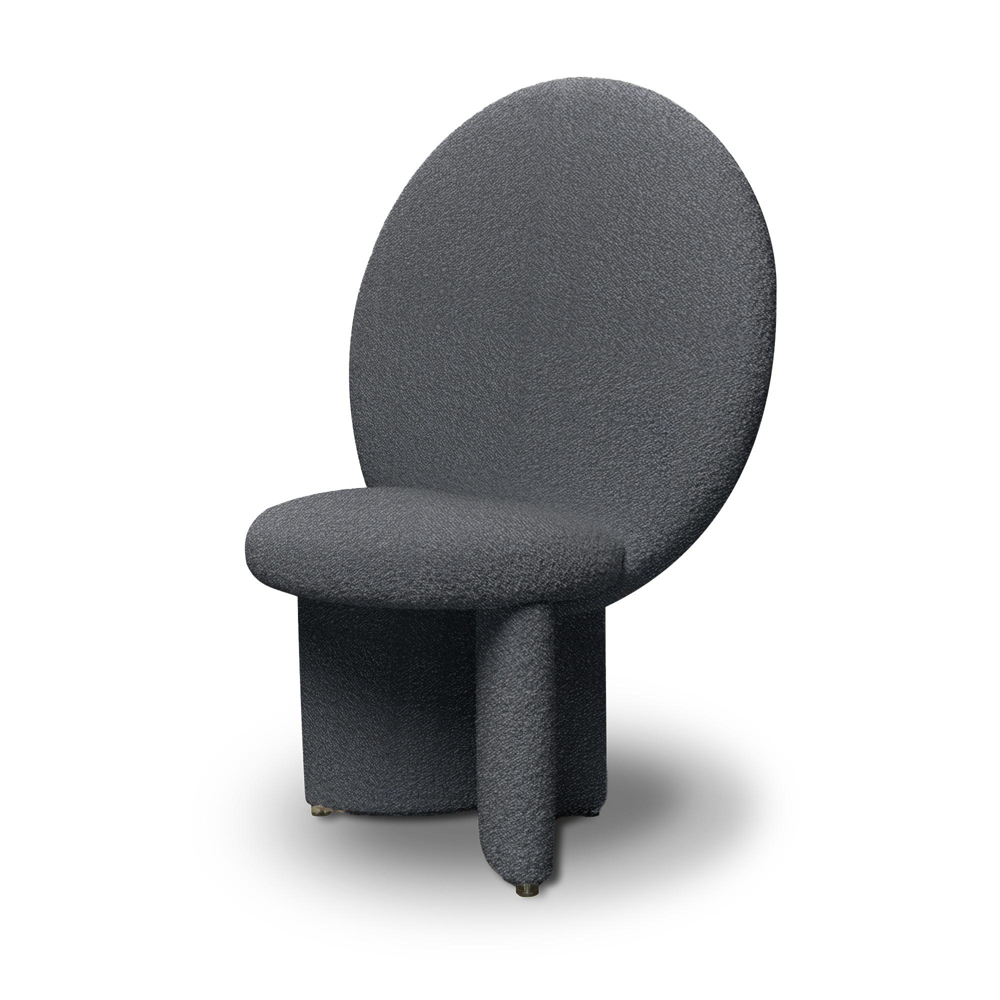 Afternoon chair has the majesty of a throne, with the huge circular backrest that reaches out and upwards, its legs curve to join the seat at angles. The chair is completely upholstered with soft, textural bouclé fabric.