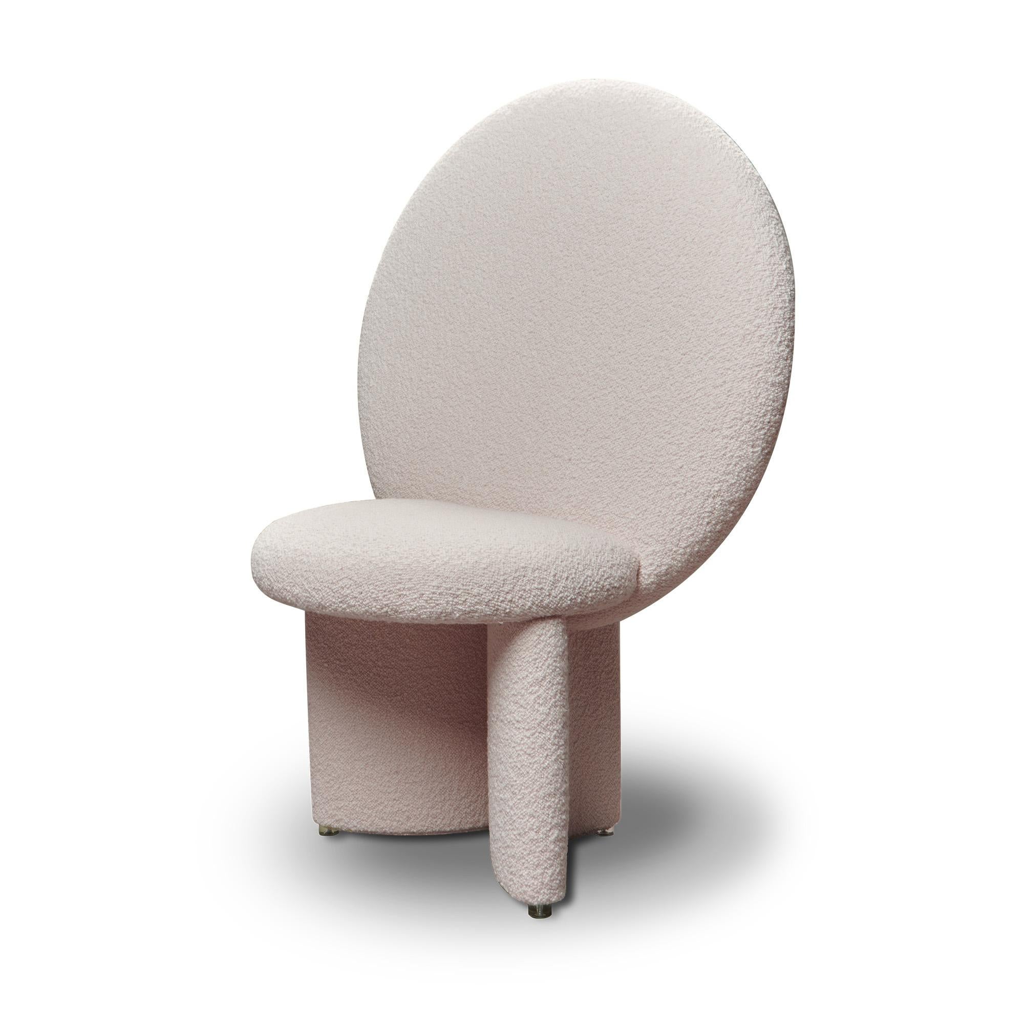 Afternoon chair has the majesty of a throne, with the huge circular backrest that reaches out and upwards, its legs curve to join the seat at angles. The chair is completely upholstered with soft, textural bouclé fabric.
