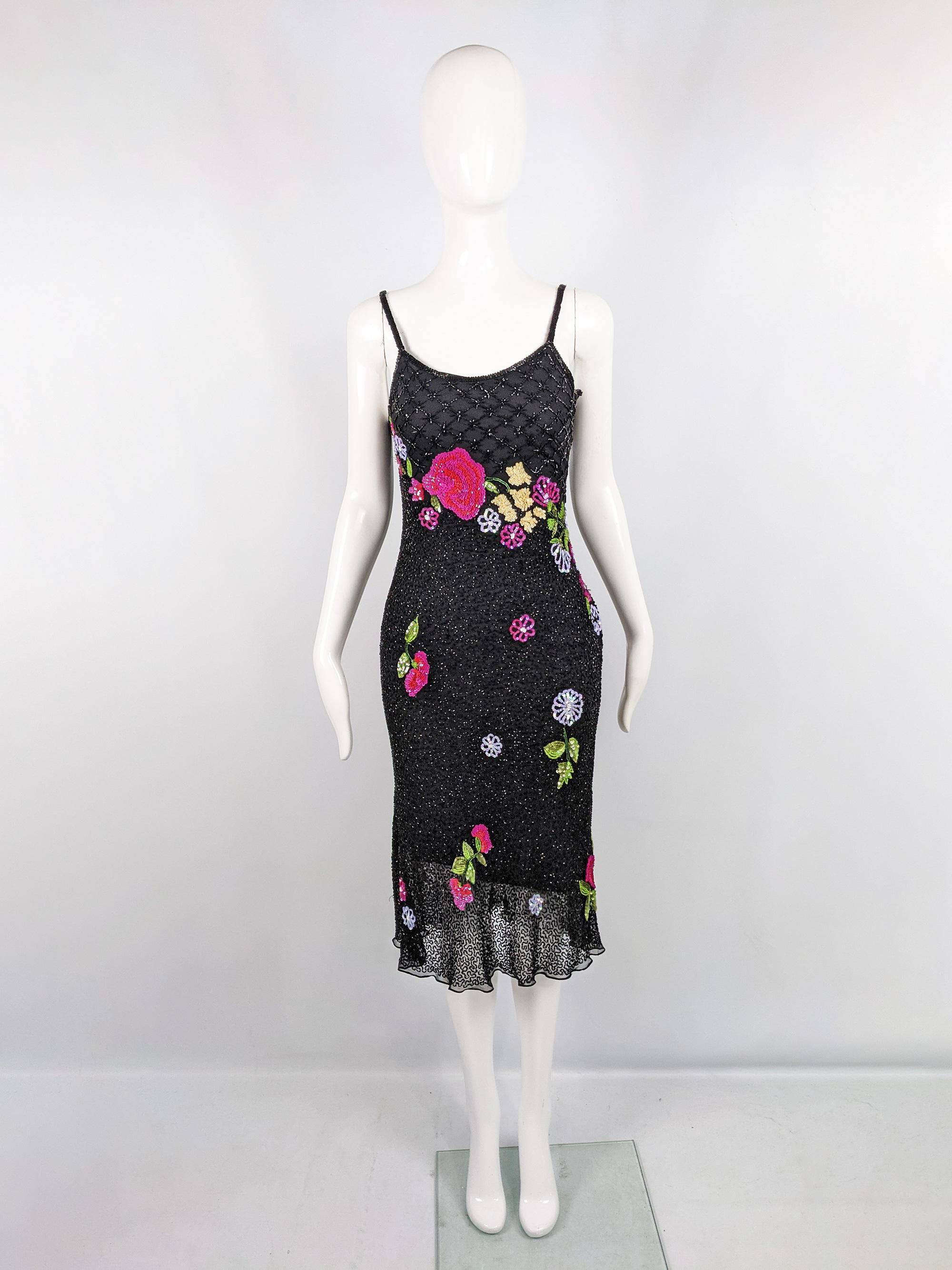 A stunning vintage womens slip dress from the 90s by quality label, Aftershock. In a black pure silk fabric embellished with glass bugle beads and colourful sequins in the shape of flowers throughout. Perfect 

Size: Marked S and measures roughly