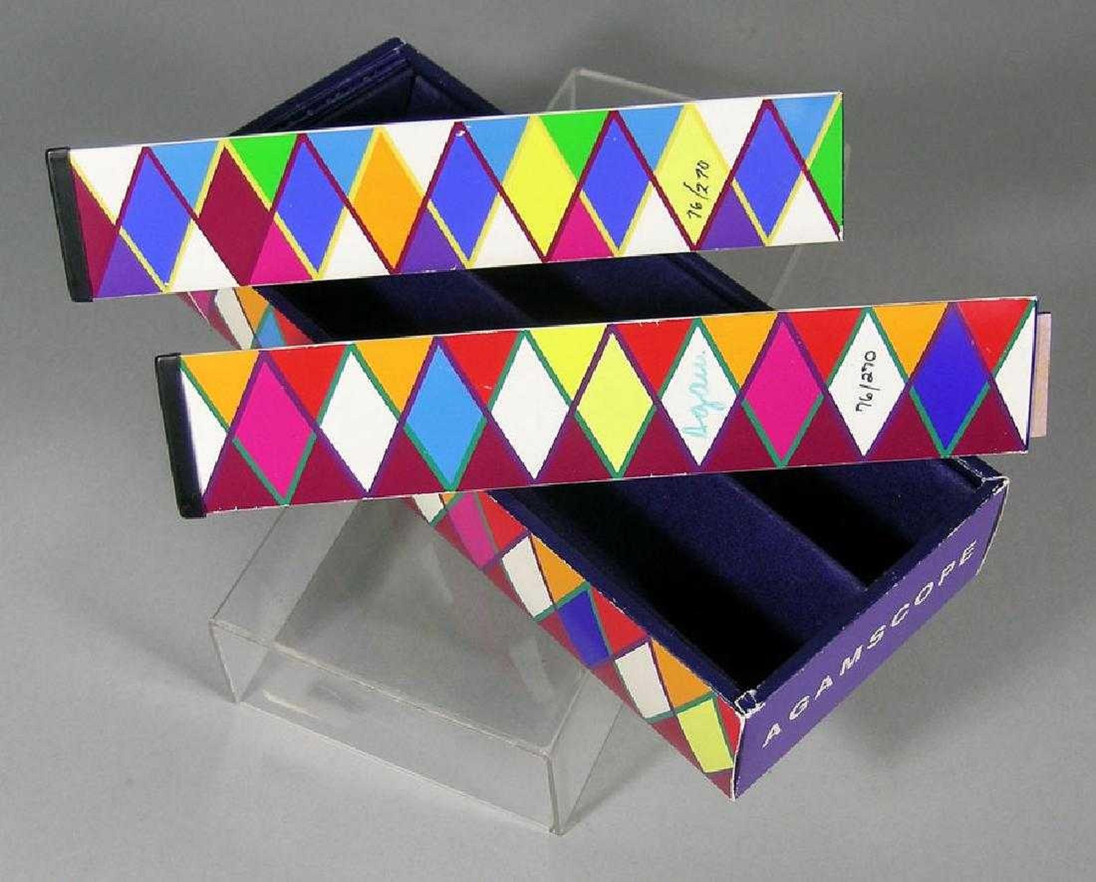 This is a rare boxed pair of Yacov Agam Agamascope Kaleidoscope devices with silkscreen paper applied, hand signed and numbered. 

biographical info: The son of a rabbi, Agam can trace his ancestry back six generations to the founder of the Chabad