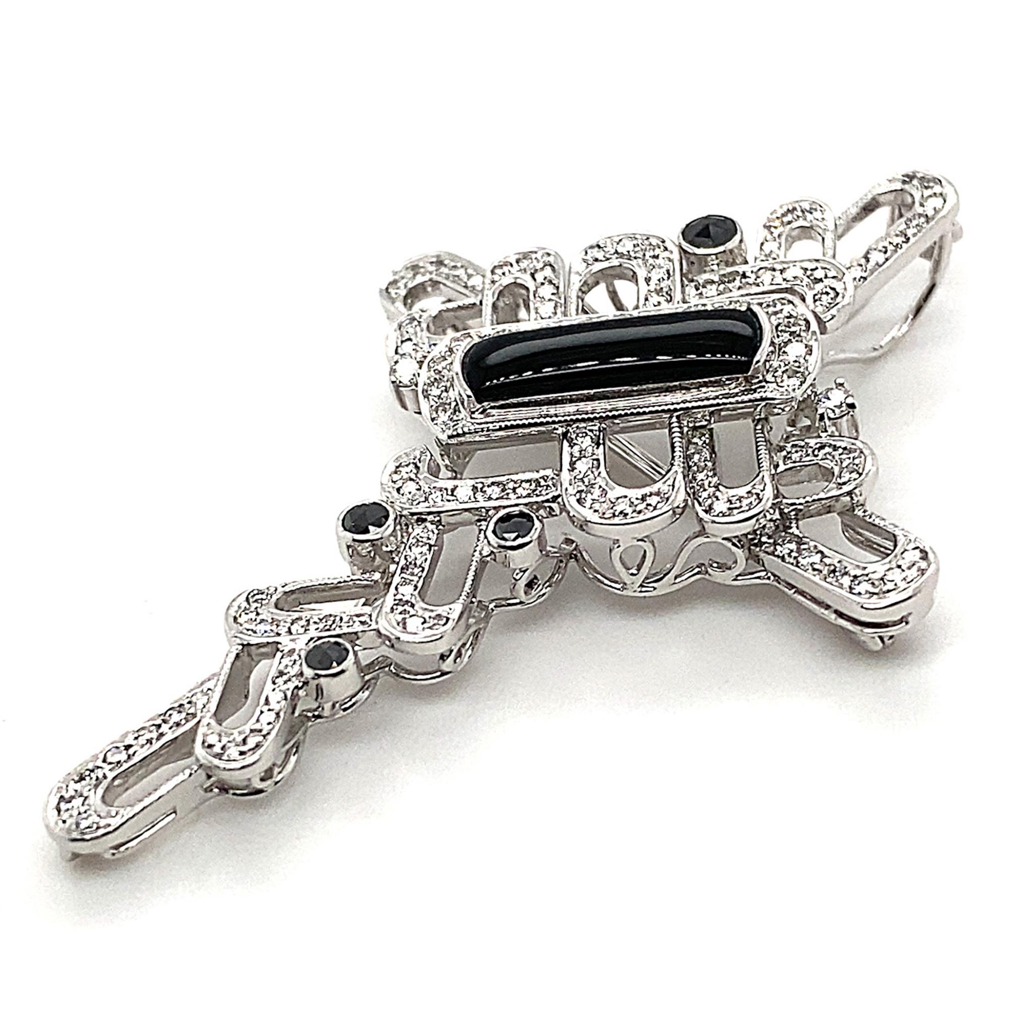 This ribbon-wrapped cross brooch gives the timeless symbol a modern twist. Mounted in 18K White Gold, the intricate and beautifully worked ribbon and cross motif are set with an Agate, weighing 0.48ct, 109 Collection Grade Round Diamonds totalling