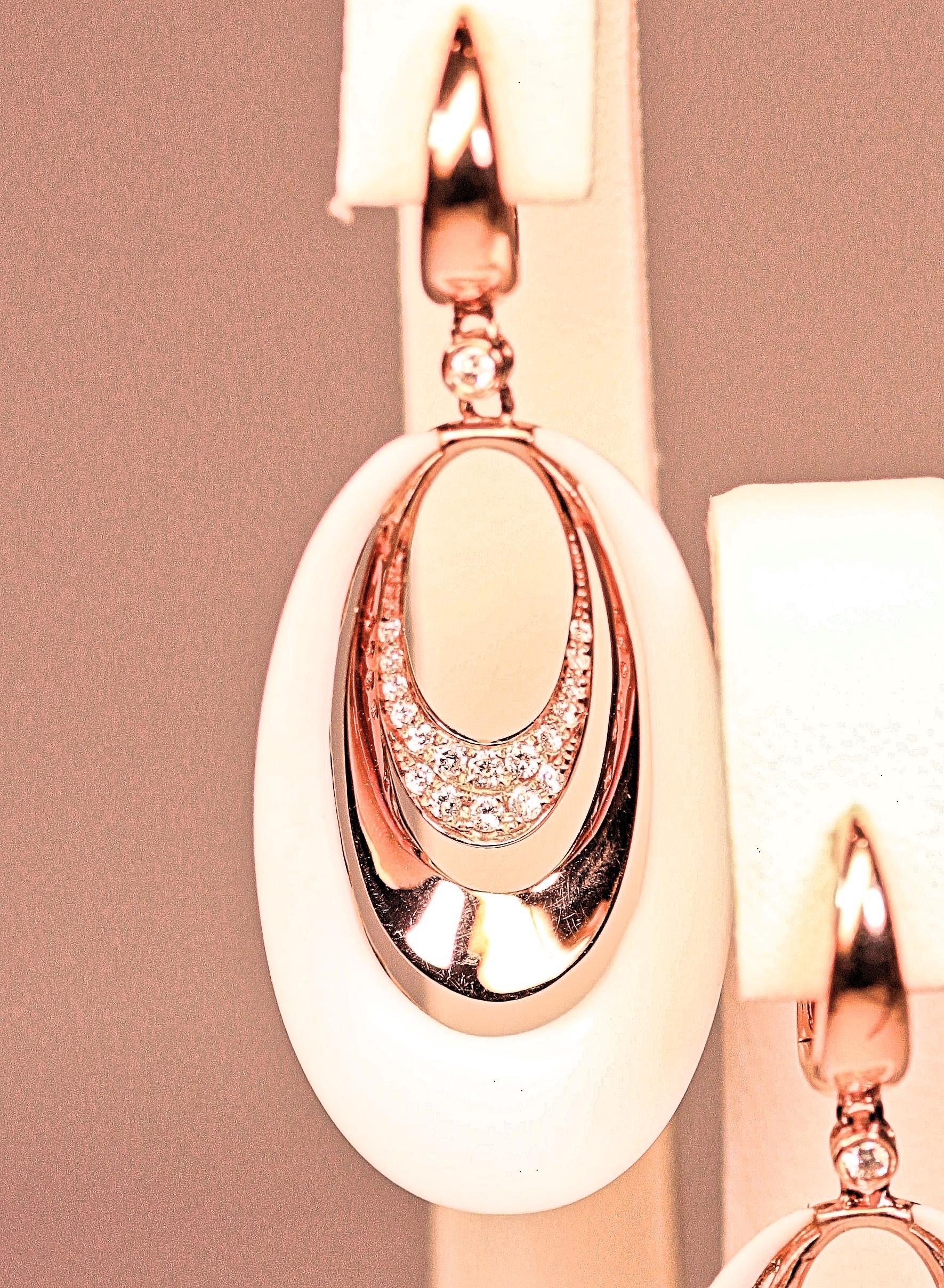 The earrings are 14 karat rose gold with white agate and diamonds.  The earrings are long dangles with oval circles of white agate, rose gold and diamonds. Beautiful summer earrings with .33 carat total weight of small round brilliant cut diamonds.