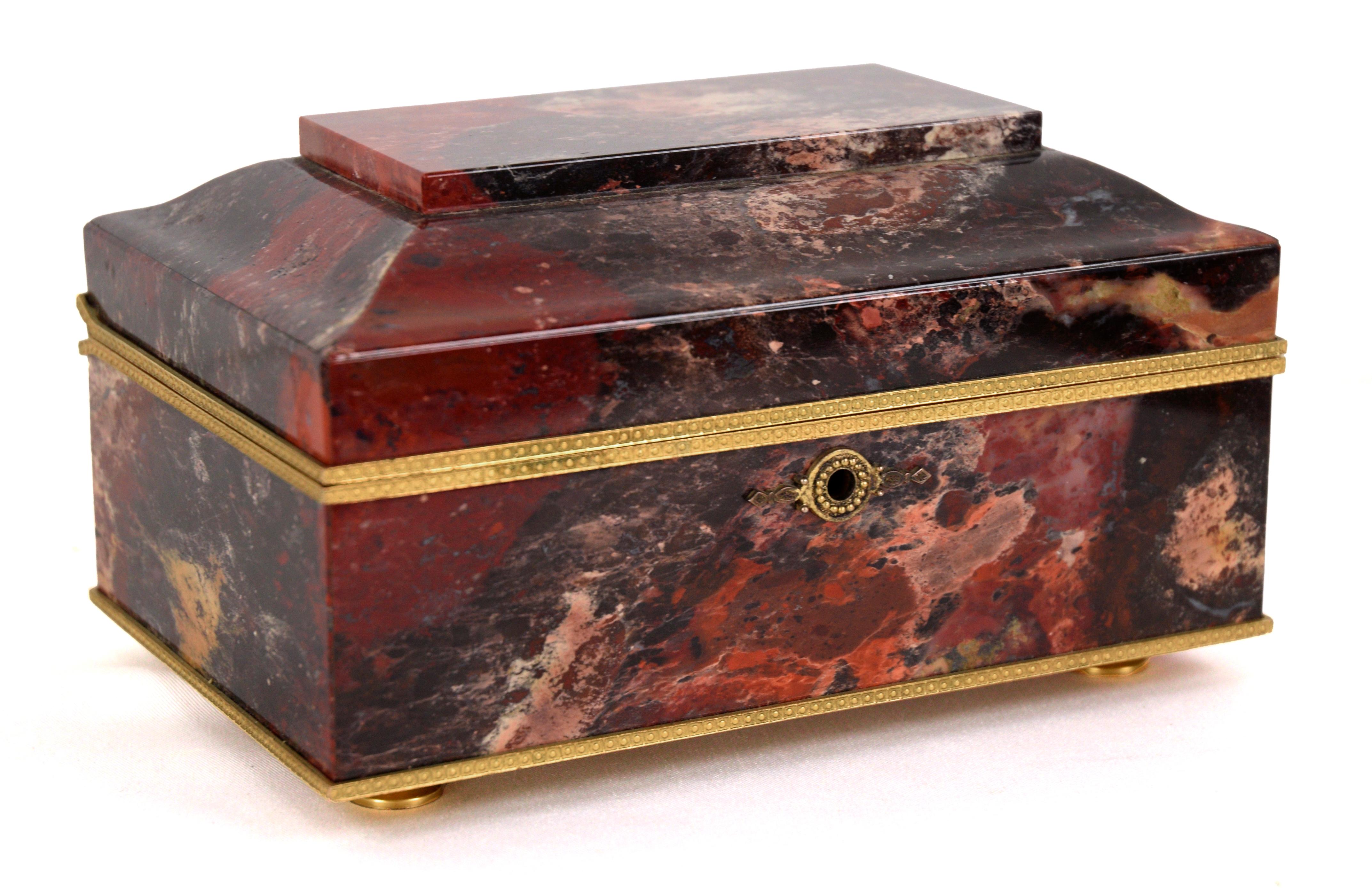 Boîte à bijoux française en agate et bronze doré, en forme de coffret en pierre rouge, noire et rose, avec couvercle à charnière s'ouvrant sur un intérieur tapissé de velours, ainsi qu'une clé cloutée de rubis, 3.5 