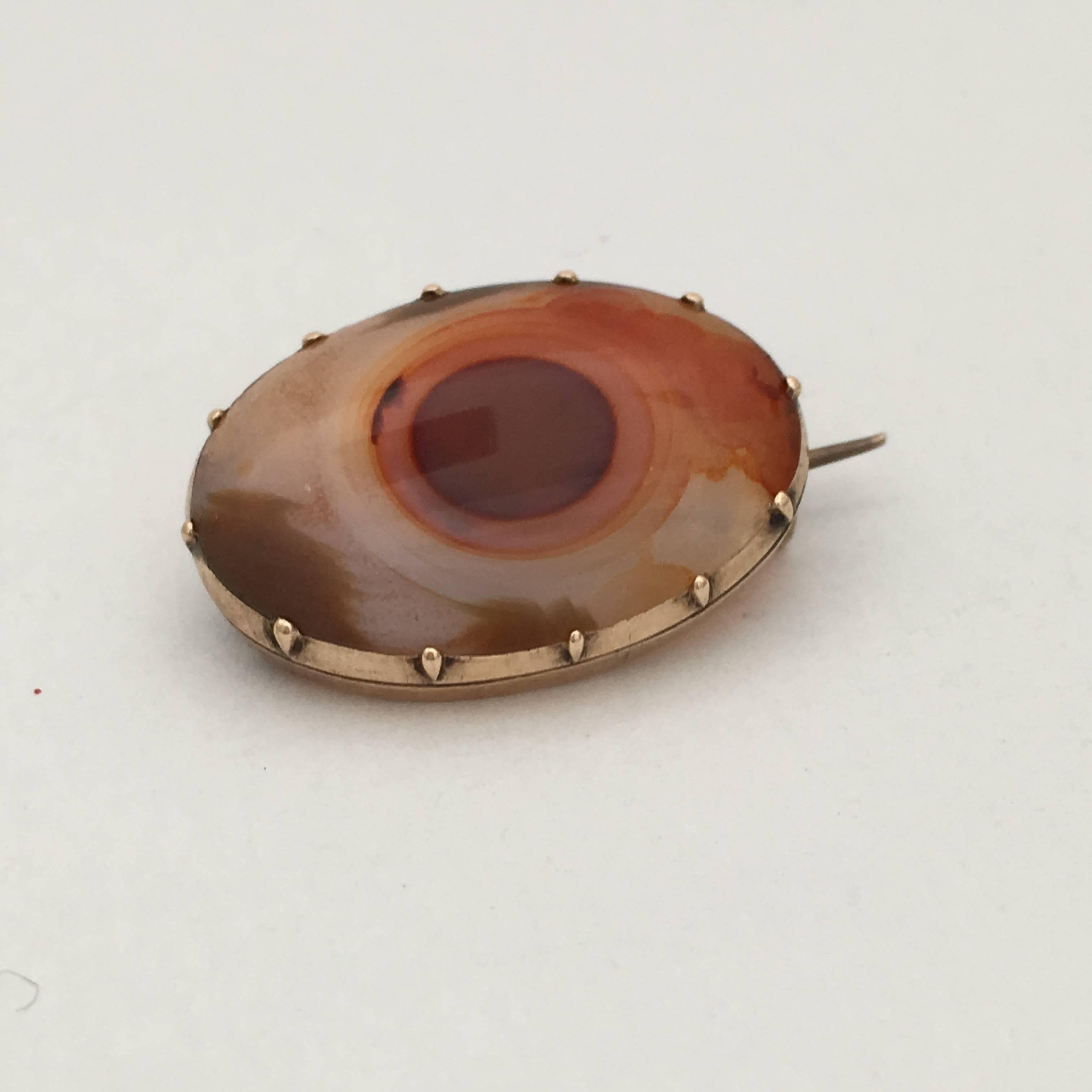 This exquisite agate lace pin is strikingly like an eye! The collet setting is typical of the Georgian period when fine brooches like these would have been worn on delicate lace shawls and collars. This unique example is a soft mix of beautifully