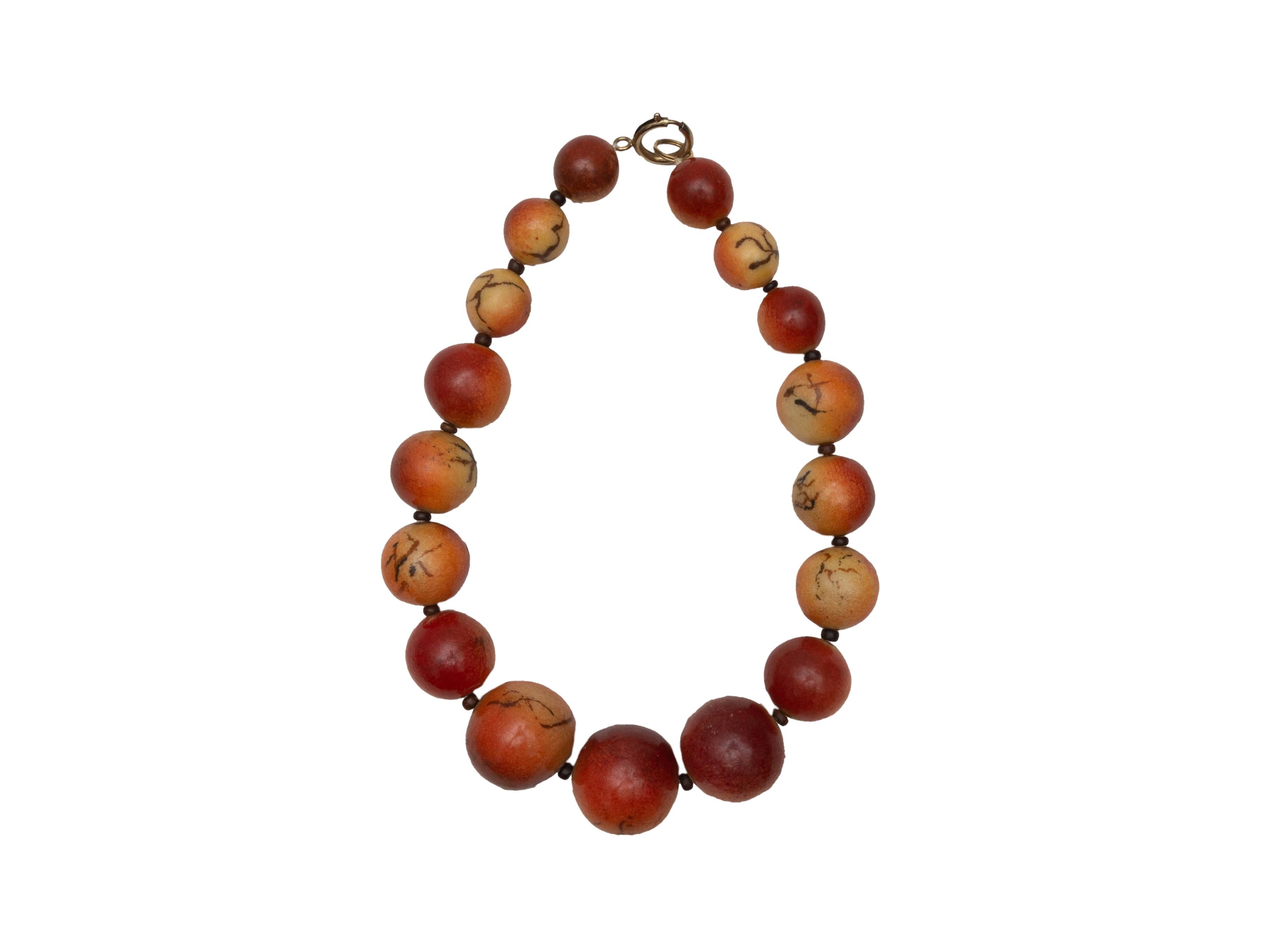 Product details: Coral large round agate bead choker. Clasp closure. 19