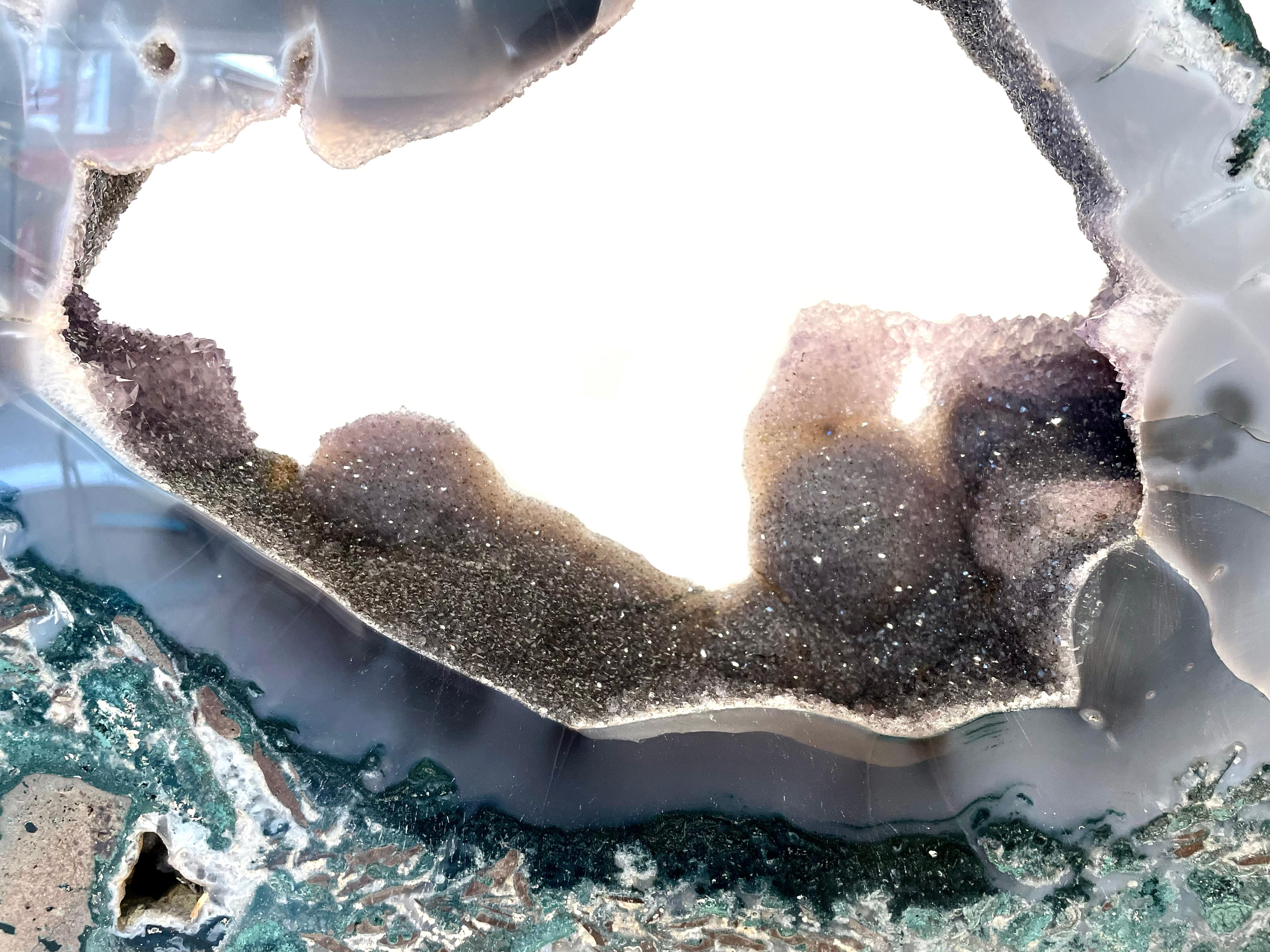 This stunning, shimmering agate crystal slice is accompanied by amethyst and quartz crystal deposits. The crystal is in excellent condition and accompanied with a bespoke display stand. 

Ethically sourced in Rio Grande du Sul, Brazil, the piece is