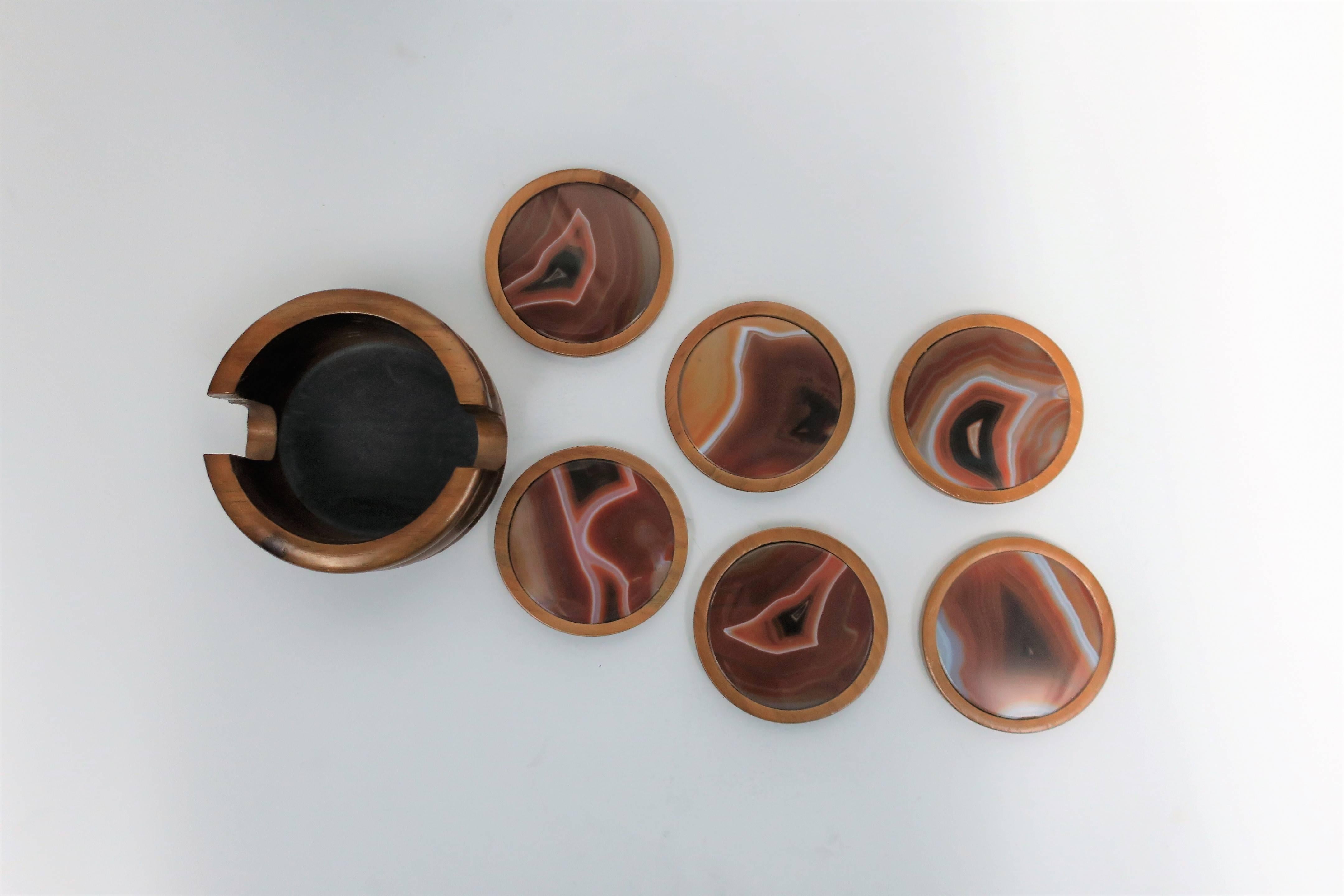 A beautiful vintage agate stone coaster set, circa 1970s. Set includes six round agate stone and wood coasters and one coaster vessel with fluted design. Seven pieces in total.

Set available here online. By request, set can be made available by
