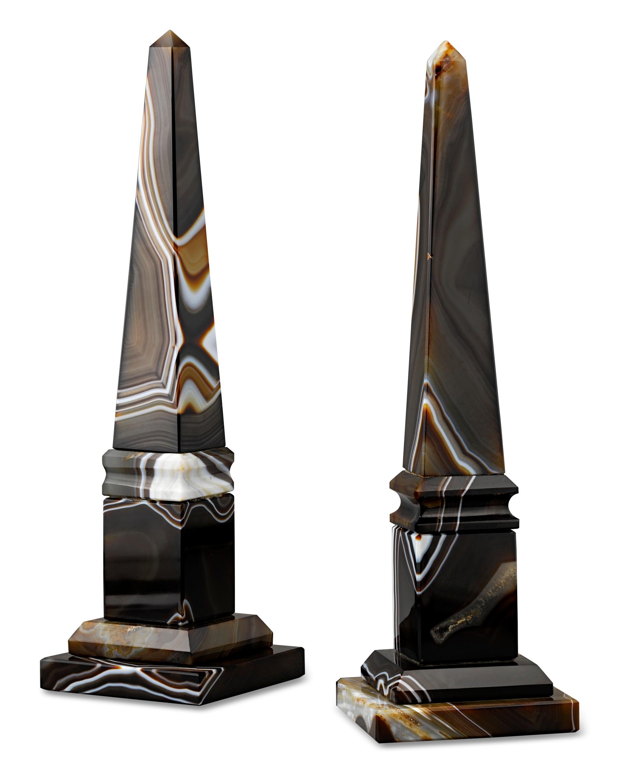 These impressive Egyptian Revival obelisks are crafted of dynamically patterned agate. The rare 19th-century models were almost certainly made in Italy during the height of the Grand Tour when the fervor for all things ancient pervaded the