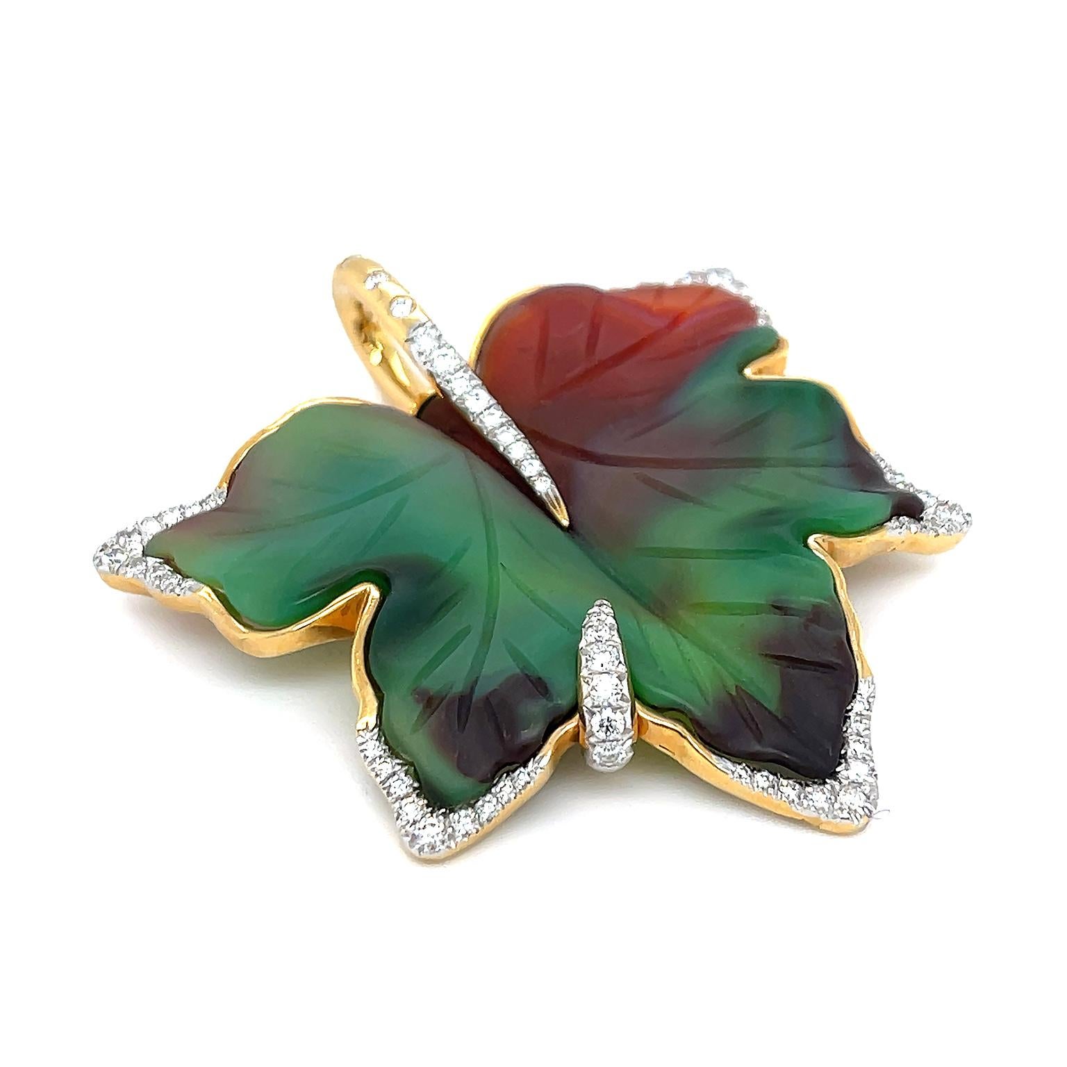 A deep earth toned agate is the focus of this leaf pendant trimmed with brilliant cut diamonds. Agate is carved in the contour of a five-pointed leaf, displaying the translucency of the gem, as shades of emerald and red brown blend into each other.
