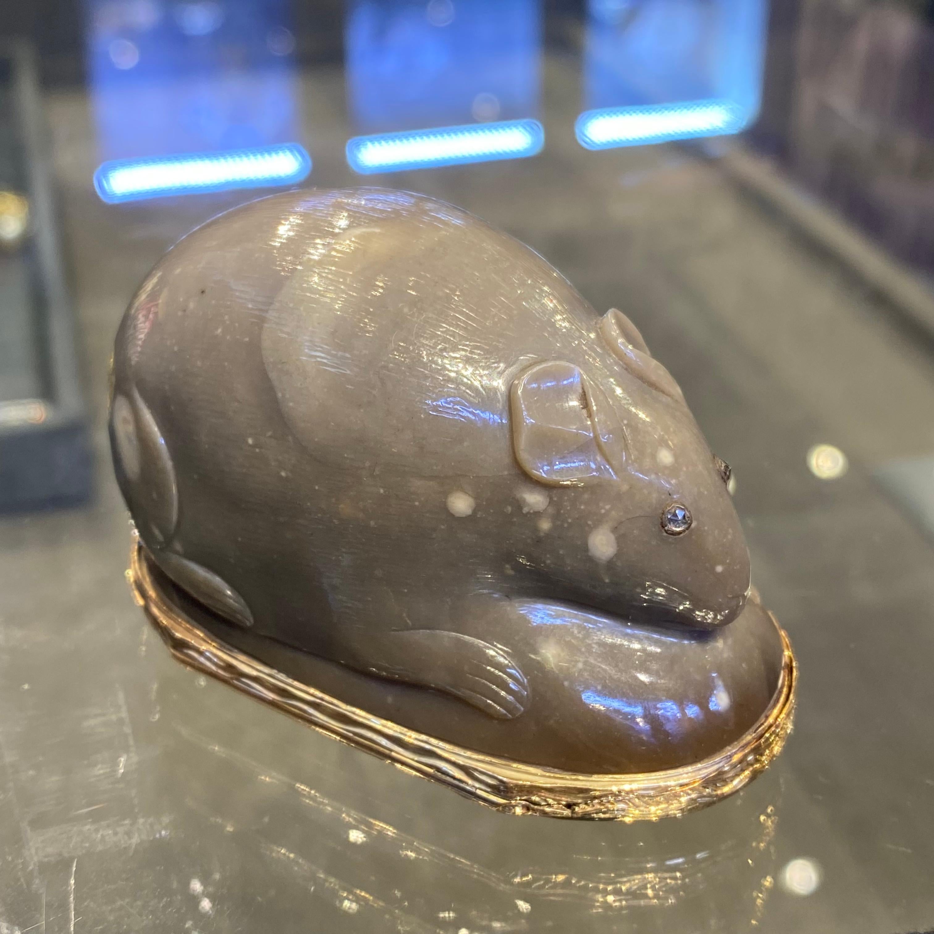 Agate Mouse Snuff Box. 

Made Circa 1760.

Crafted from grey agate carved in the form of a mouse. This snuff-box features a rose gold mount. With a thumbpiece embellished with diamonds and rubies, forming a fruiting branch motif. The hinged cover is