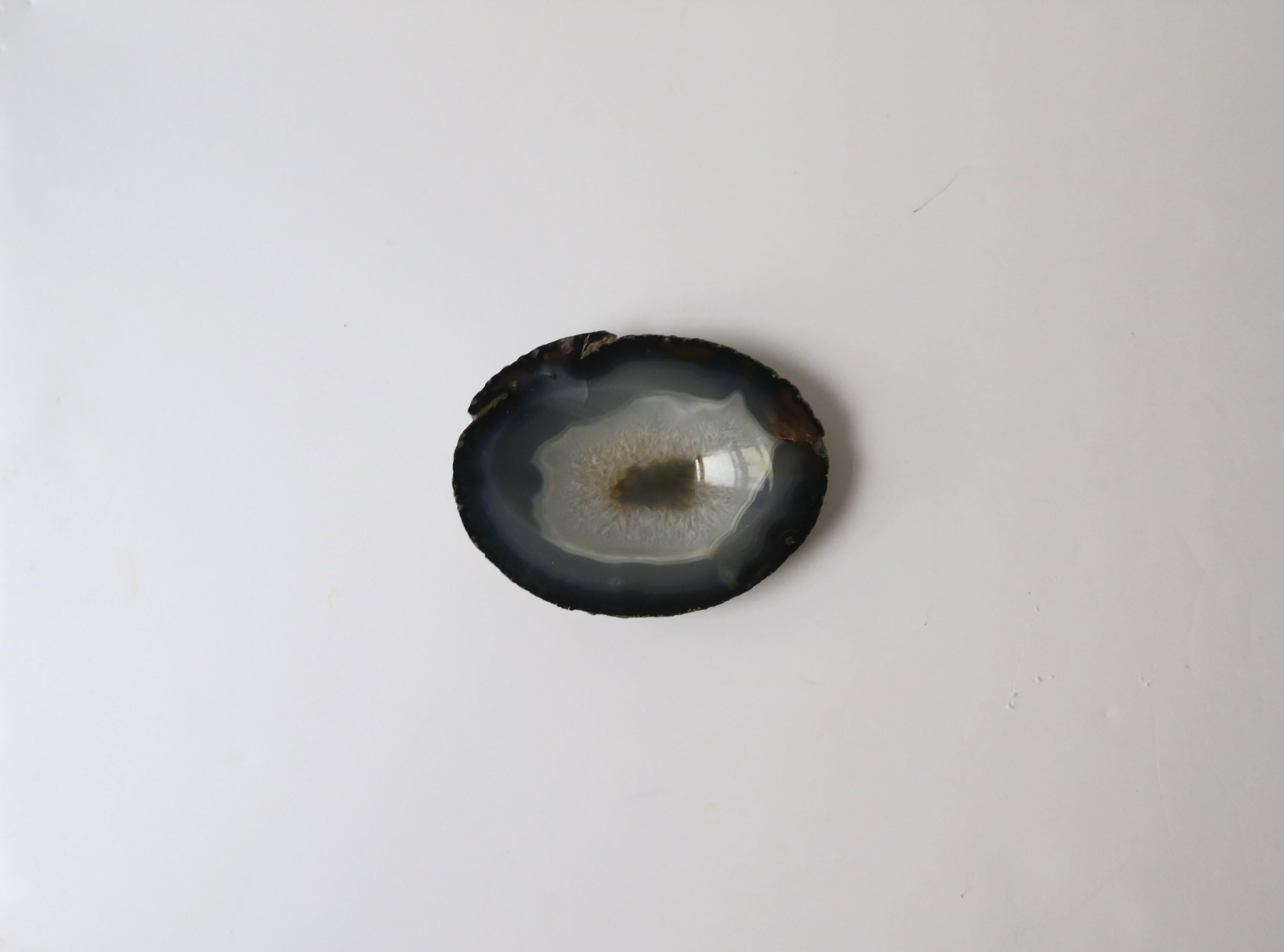 A beautiful, natural, blue/dark gray onyx agate dish, decorative object, or small bowl/vessel in the organic modern style. Piece can work as a small jewelry dish (demonstrated), a standalone decorative piece, or paperweight/desk accessory for small
