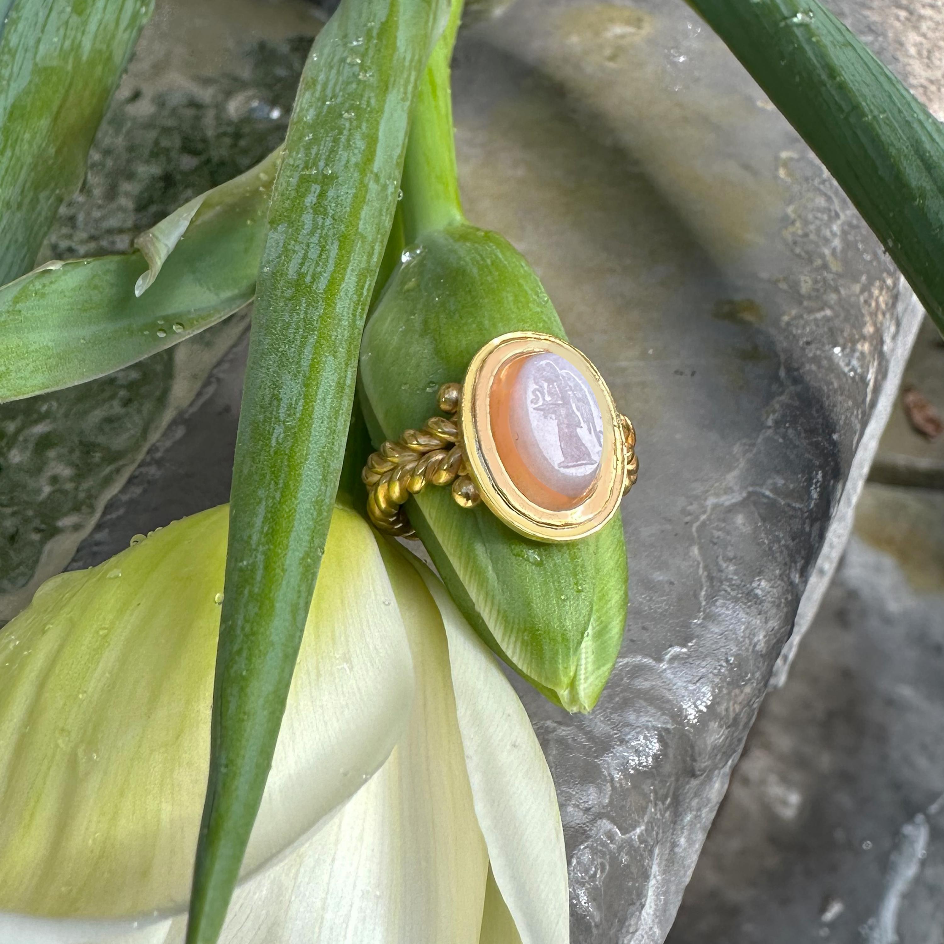 This 18 Kt gold ring, meticulously crafted by our skilled goldsmiths, showcases an authentic Roman two layer agate intaglio dating back to the 1st-2nd century AD.

The intaglio depicts the goddess Nike, personifying victory, in a powerful and sacred