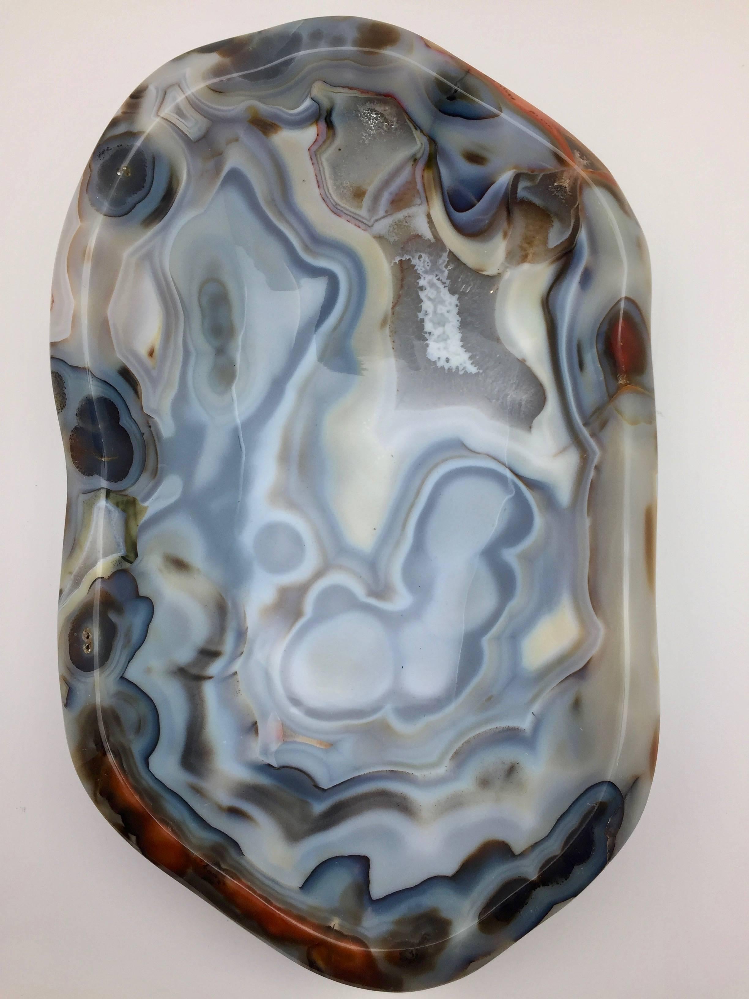 Beautiful, hand-carved giant agate vide-poche from Madagascar, selected for it's broad spectrum of colors and unusually large size. A very impressive desk or table item it can also be used as receptacle for keys etc, which is where the name