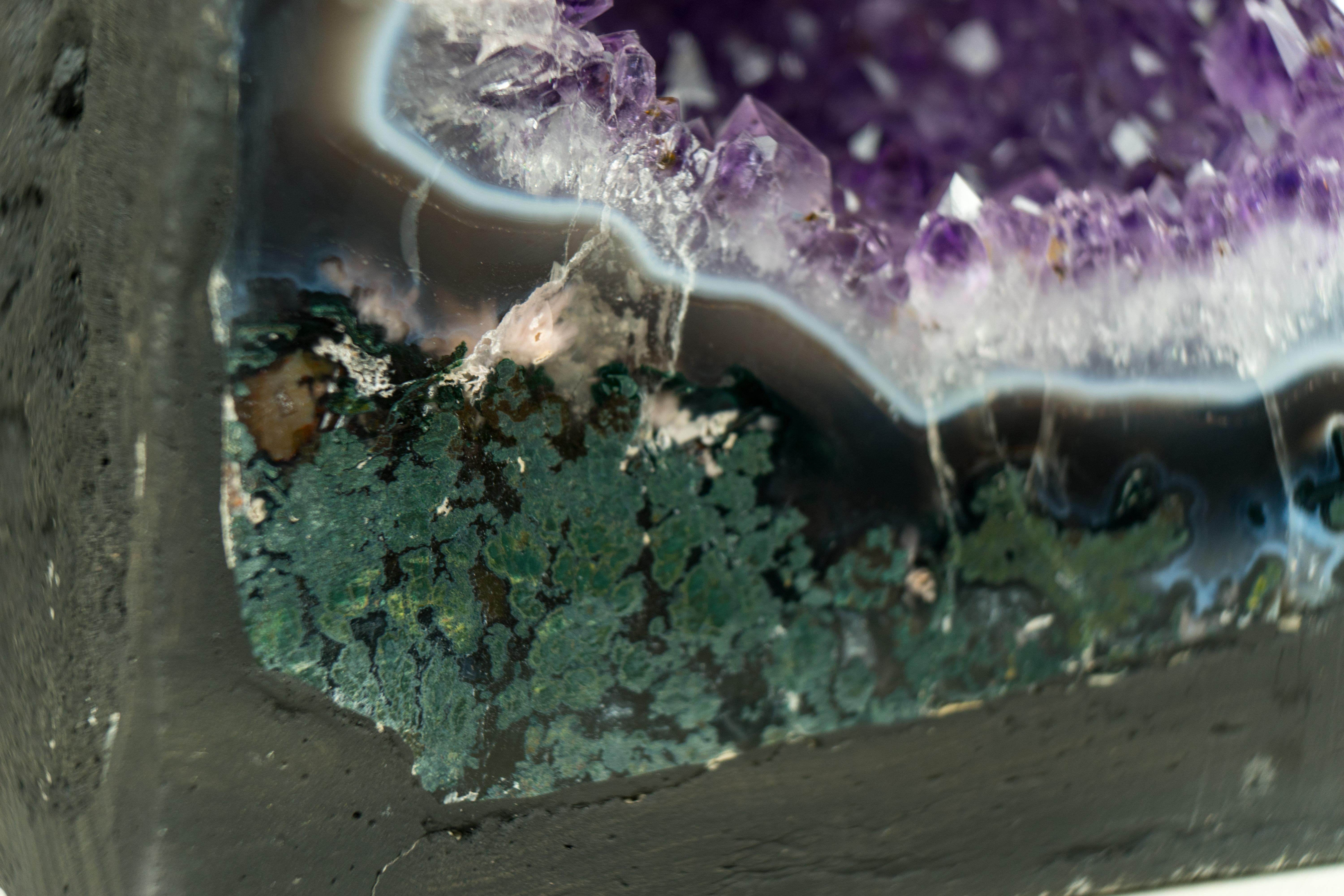 An Agate with Amethyst geode cathedral that is adorned with special characteristics, such as delicate agate laces and shimmering lavender amethyst, and if you're finding a captivating piece for your home, office, or crystal collection, this natural