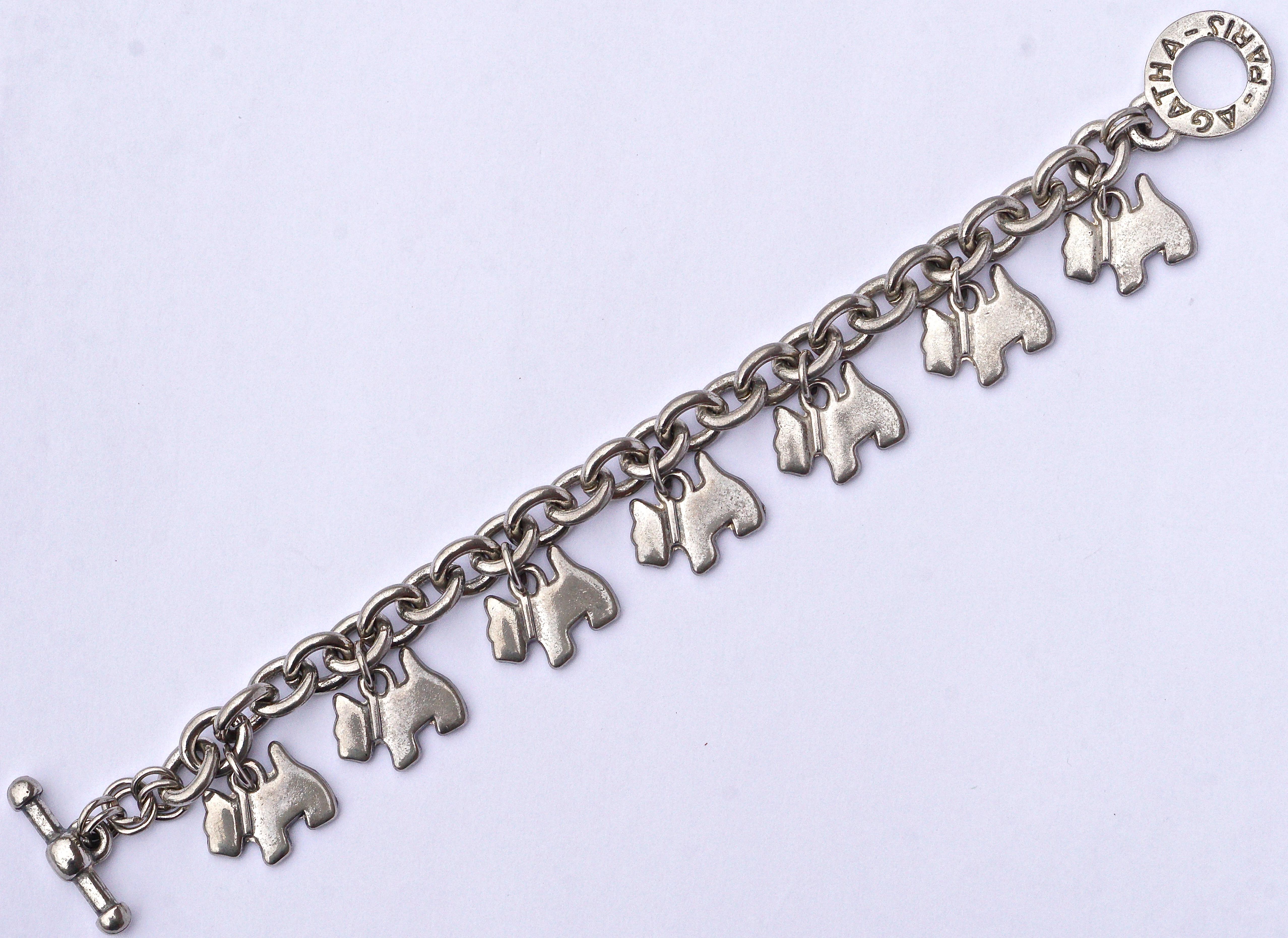 Agatha Paris silver tone bracelet with a toggle clasp, featuring the Agatha scottie dog emblem, circa 1980s. The chain bracelet is chunky and has seven lovely scottie dog charms in all. Measuring length 20.5cm / 8.07 inches, and the links measure