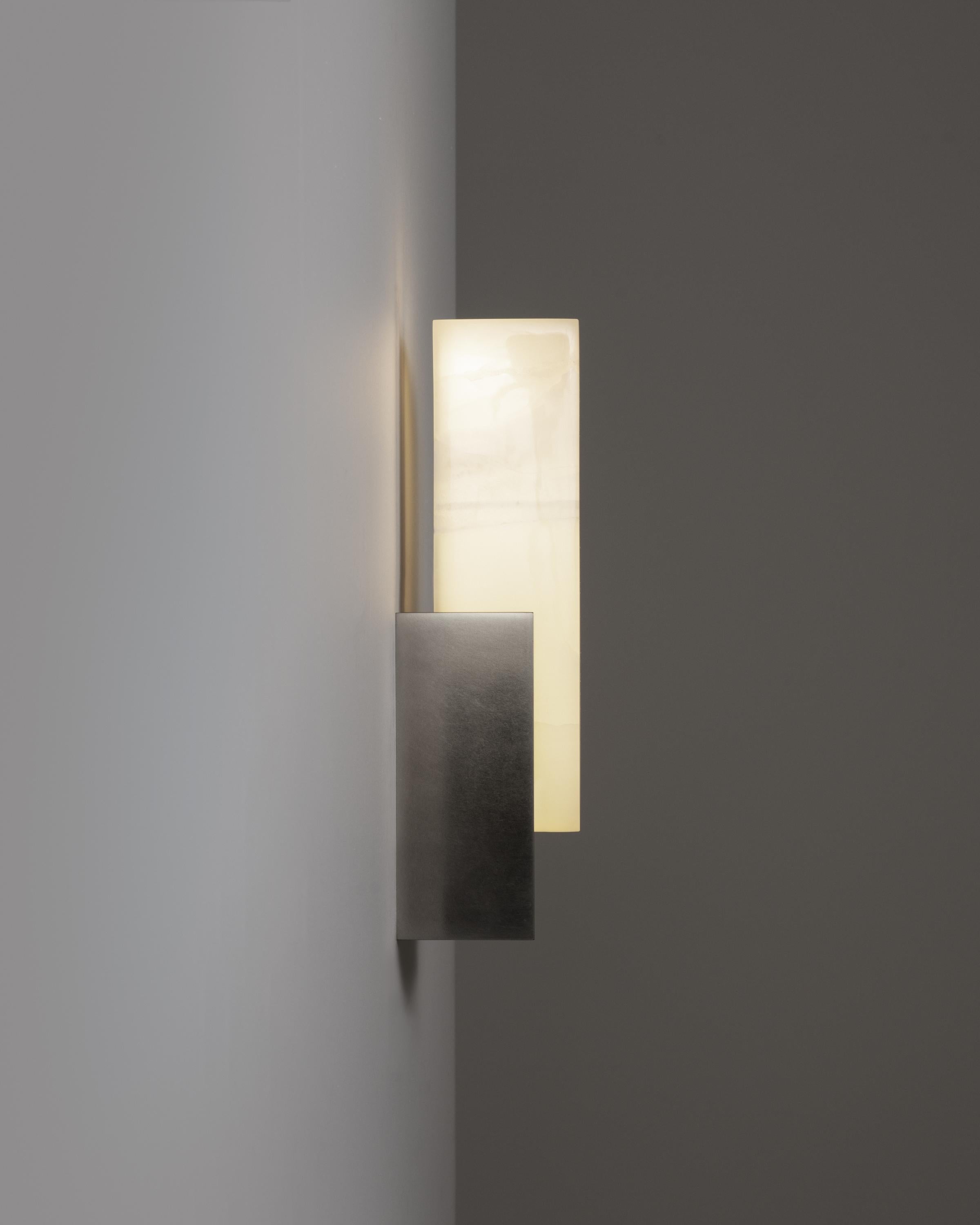The Agatha Sconce marries brushed metal and alabaster in an elegant and versatile architectural form. This seemingly simple design masks a triumph of engineering that harnesses cutting-edge LED technology, eliminating hot spots and resulting in an