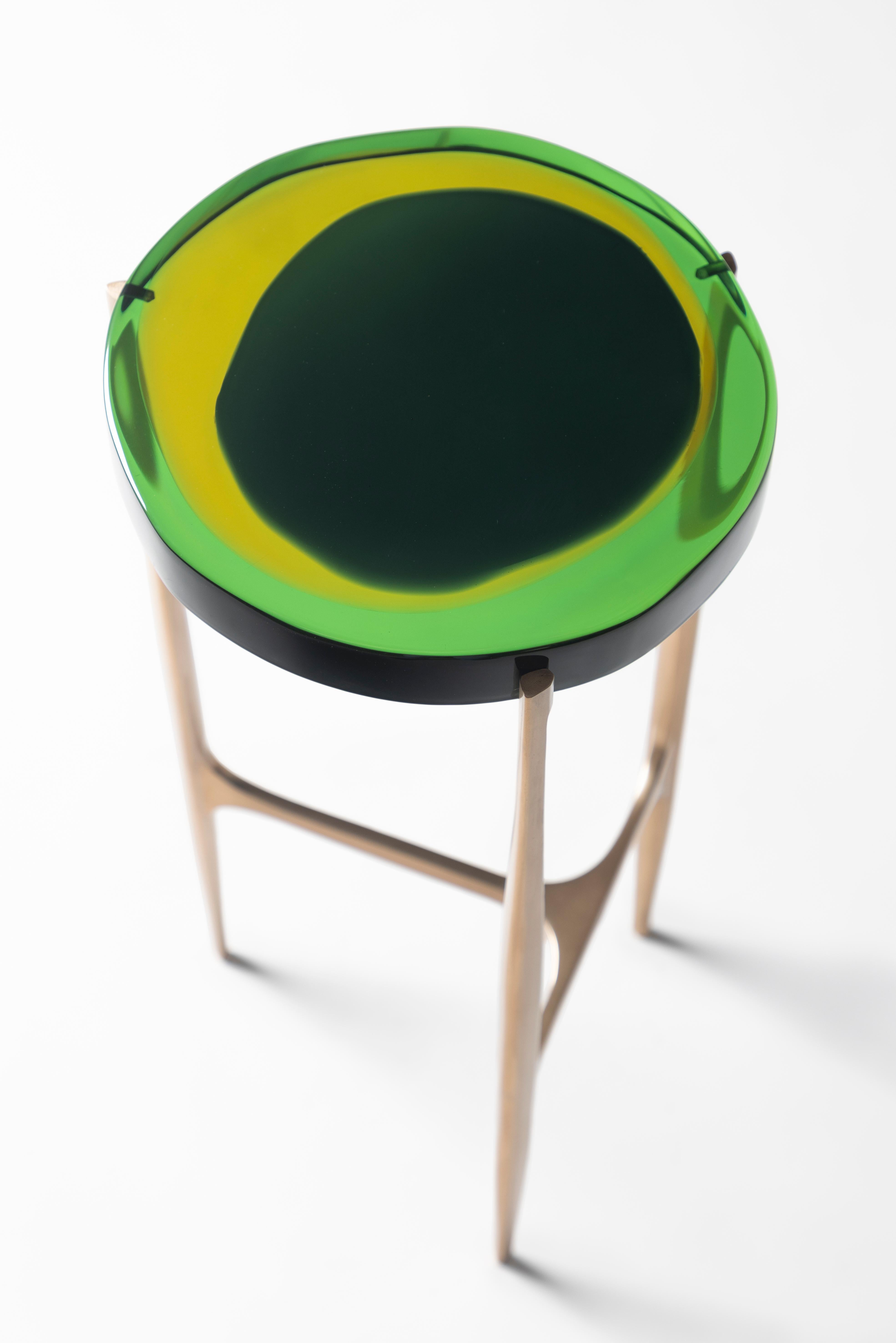 Agatha coffee table series is enlivened by an irregular circular top in transparent epoxy
resin that holds a dialogue with light. The vibrant colors are poured in several layers
to create a deep and fluid compound, embedded in a matte-effect bronze