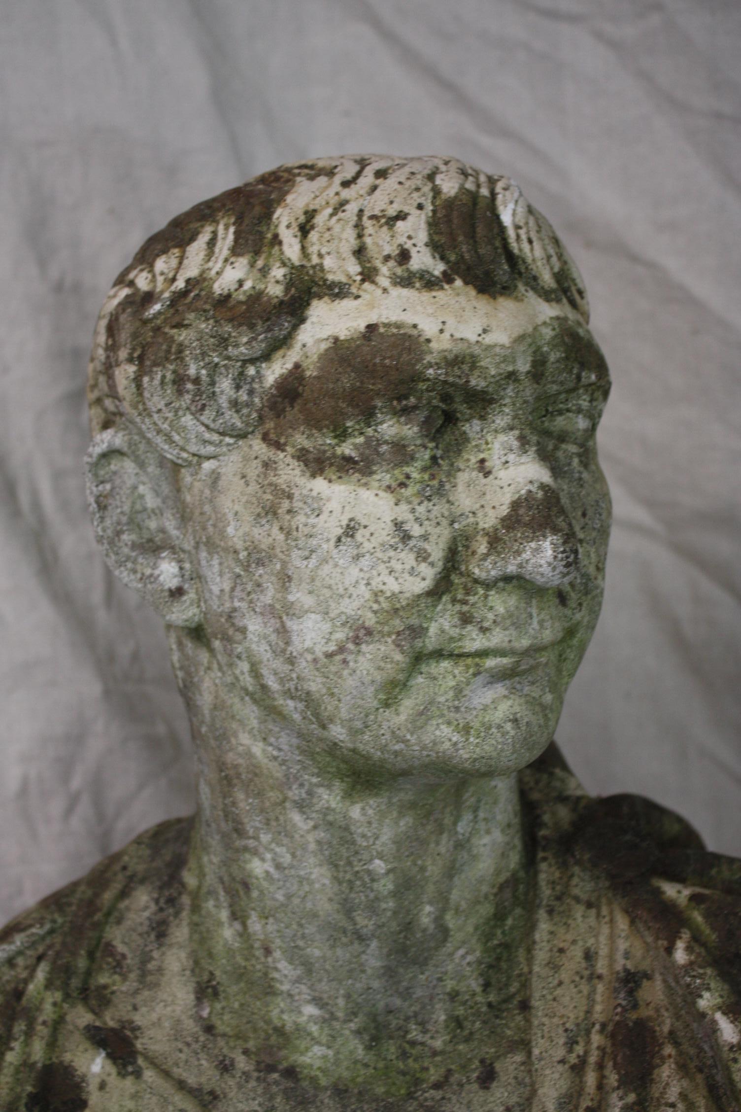 This is a great looking French bust that dates to the early 1900s. It is made of reconstituted stone. It has a very nice patina with moss and lichen growth. It is very decorative. It can be used inside or out.
