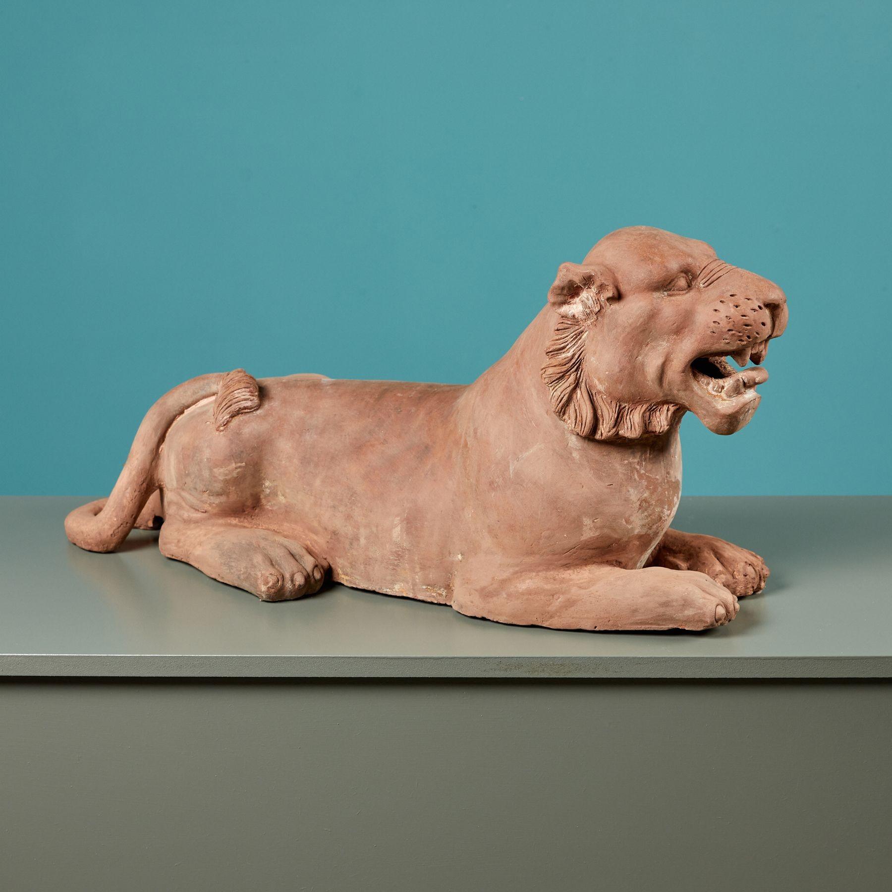 Hand-crafted over a century ago, this statue is a beautiful object for an interior. Delicate details across the mane, face and teeth have been preserved throughout the years, the red terracotta lightly weathered from age, with historic repairs to