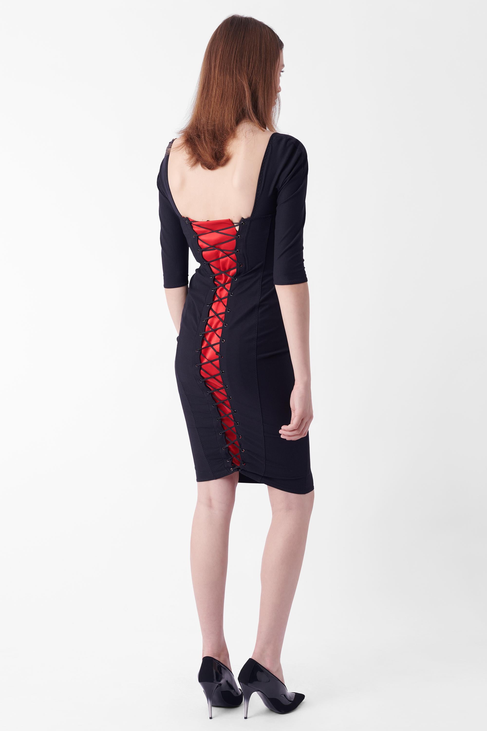We are excited to present this Agent Provocateur Fall Winter 2011 iconic Thora dress. Features sweetheart cup detailing, cross front detailing, lace up back with red satin underlay in midi length. As seen in a number of campaigns. In excellent