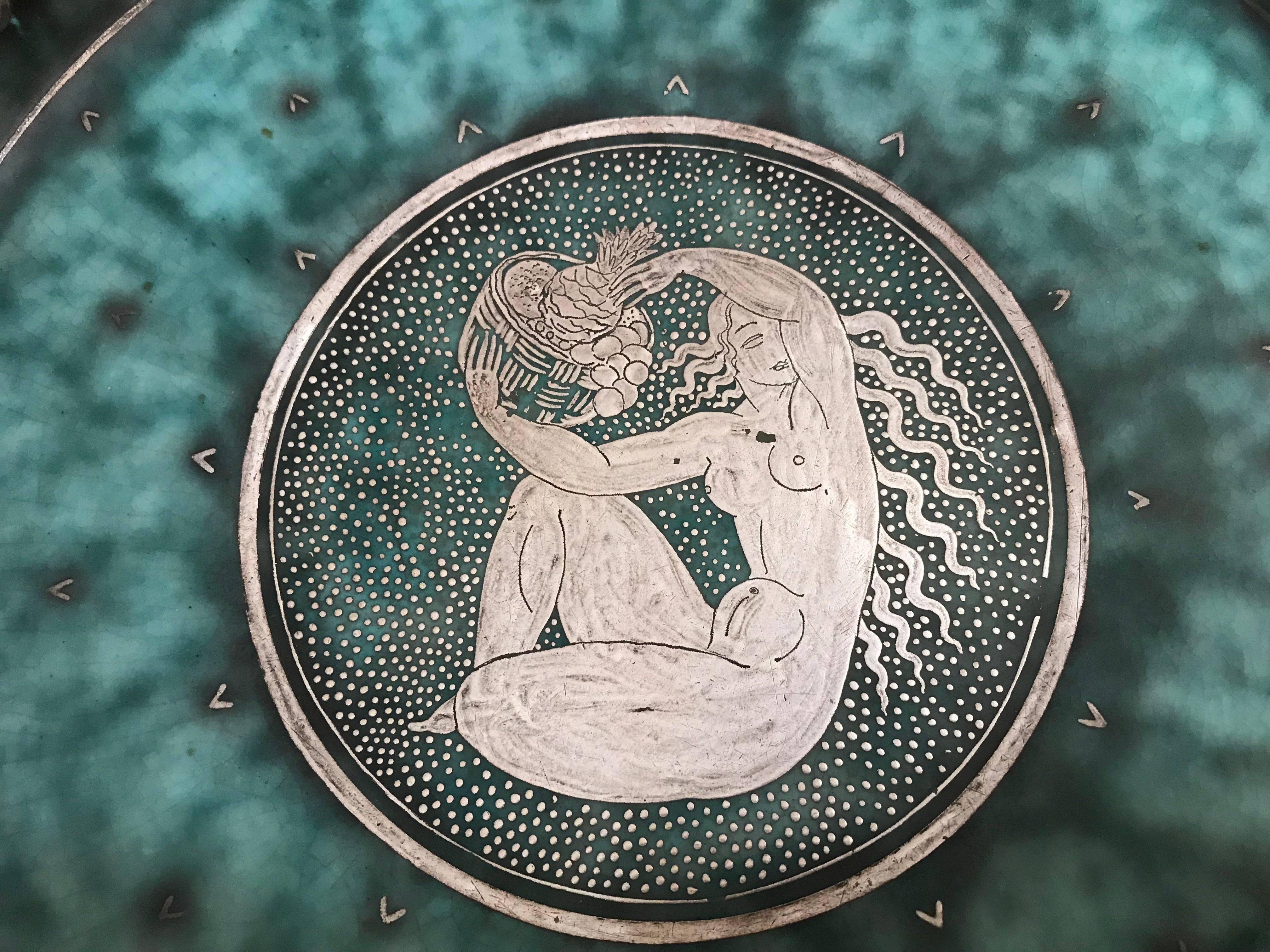 Art Deco Argenta dish with silver decoration depicting a classical Art Deco female figure. Designed by Wilhelm Kage for Gustavsberg Sweden. This piece is signed in silver by Kage. This is an early piece from the series.