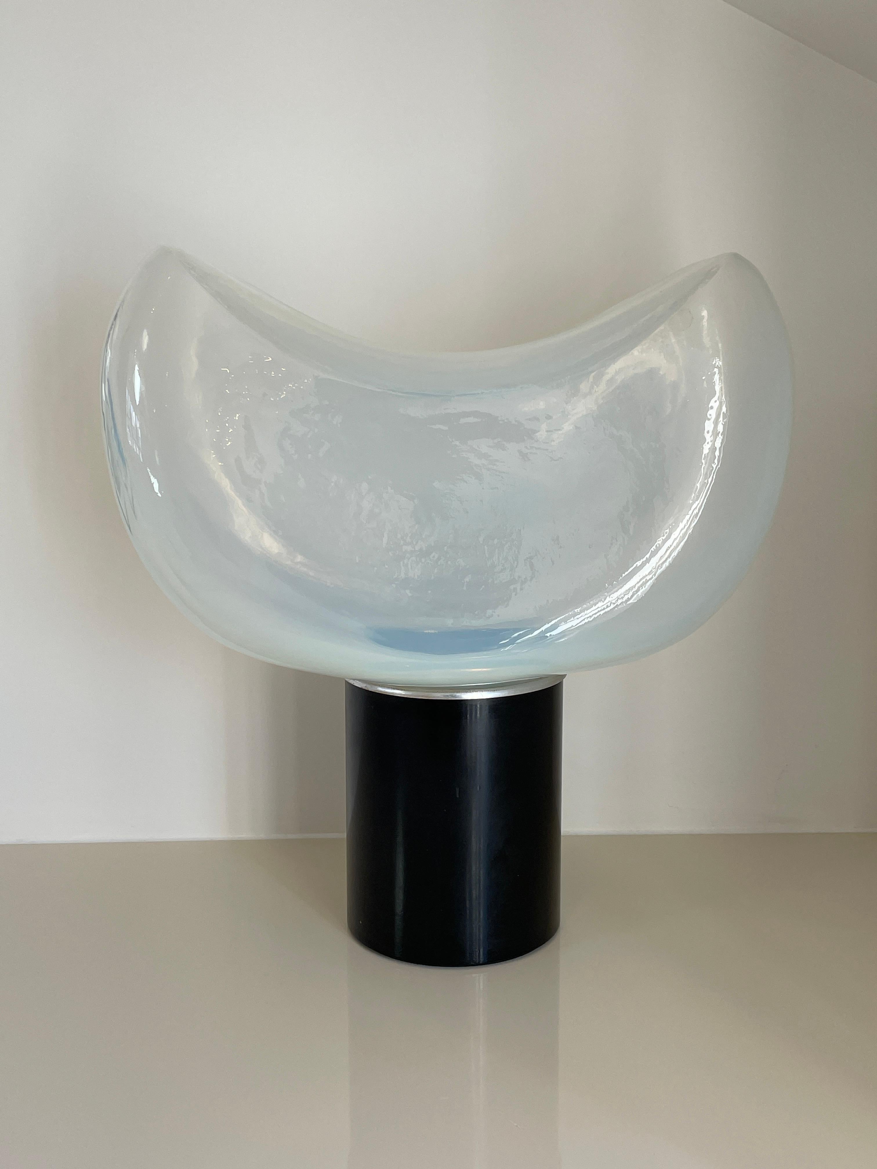 Height: 52cm
Width: 50cm
Depth: 25cm

Designer: Roberto Pamio
Manufacturer: Leucos, Italy
Date: 1960s
Materials: Blown glass, metal

Description: On a cylindrical black metal base stands a sculptural light in the shape of this celestial yet modern