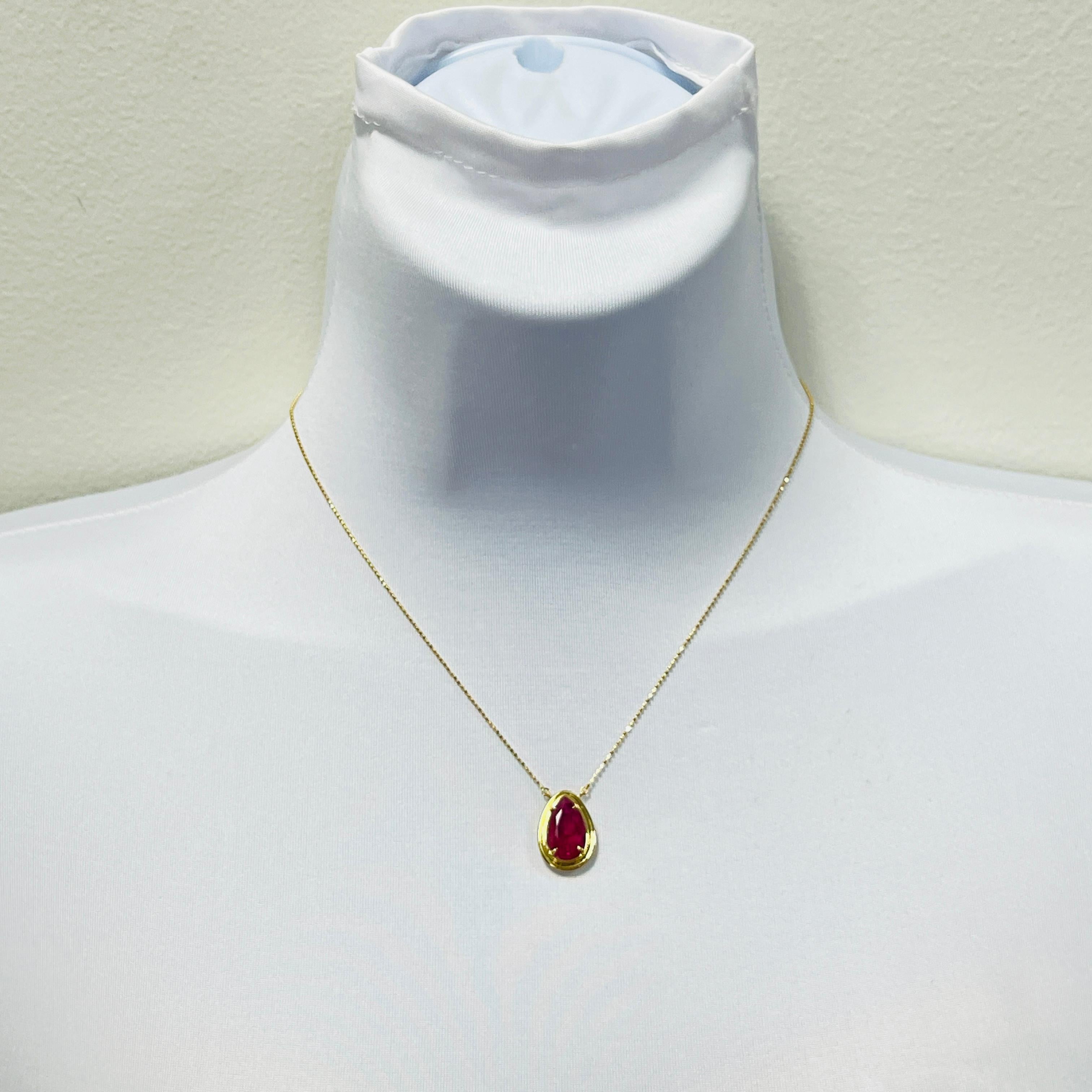Beautiful 4.38 ct. AGL Mozambique ruby pear shape in a handmade 18k yellow gold bezel and chain.  Length is 16