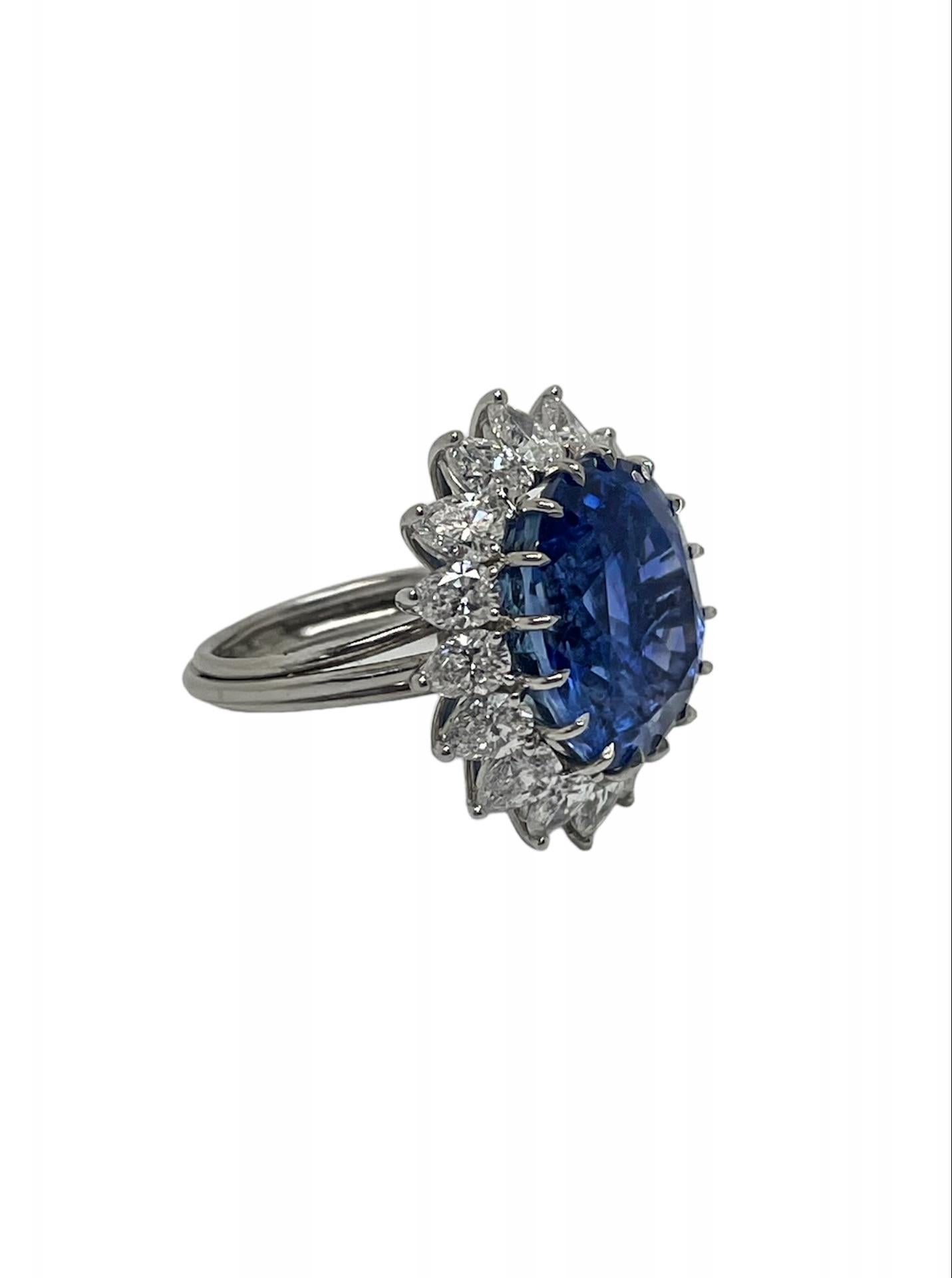 This showstopper cocktail ring features a bright and lively 20.36 carat Burma Unheated Sapphire with an amazing cornflower blue color, surrounded by an array of top quality pear shaped diamonds weighing approximately 4.55 carats total. With a