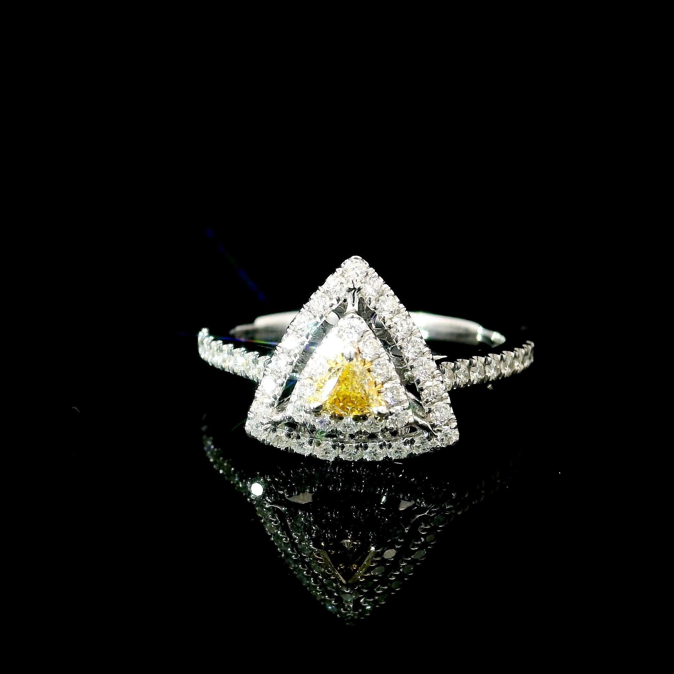 18kt white gold ring with diamonds
  
  Gold colour & karat: White gold 18kt
  Weight: 3.01 grams
  
  Set with-
  Stone type: Diamonds
  Shape: Triangle
  Carat: 0.068
  Colour: Fancy Yellow
  Clarity: VS
  
  Surrounding Stones: Diamonds
 1) White