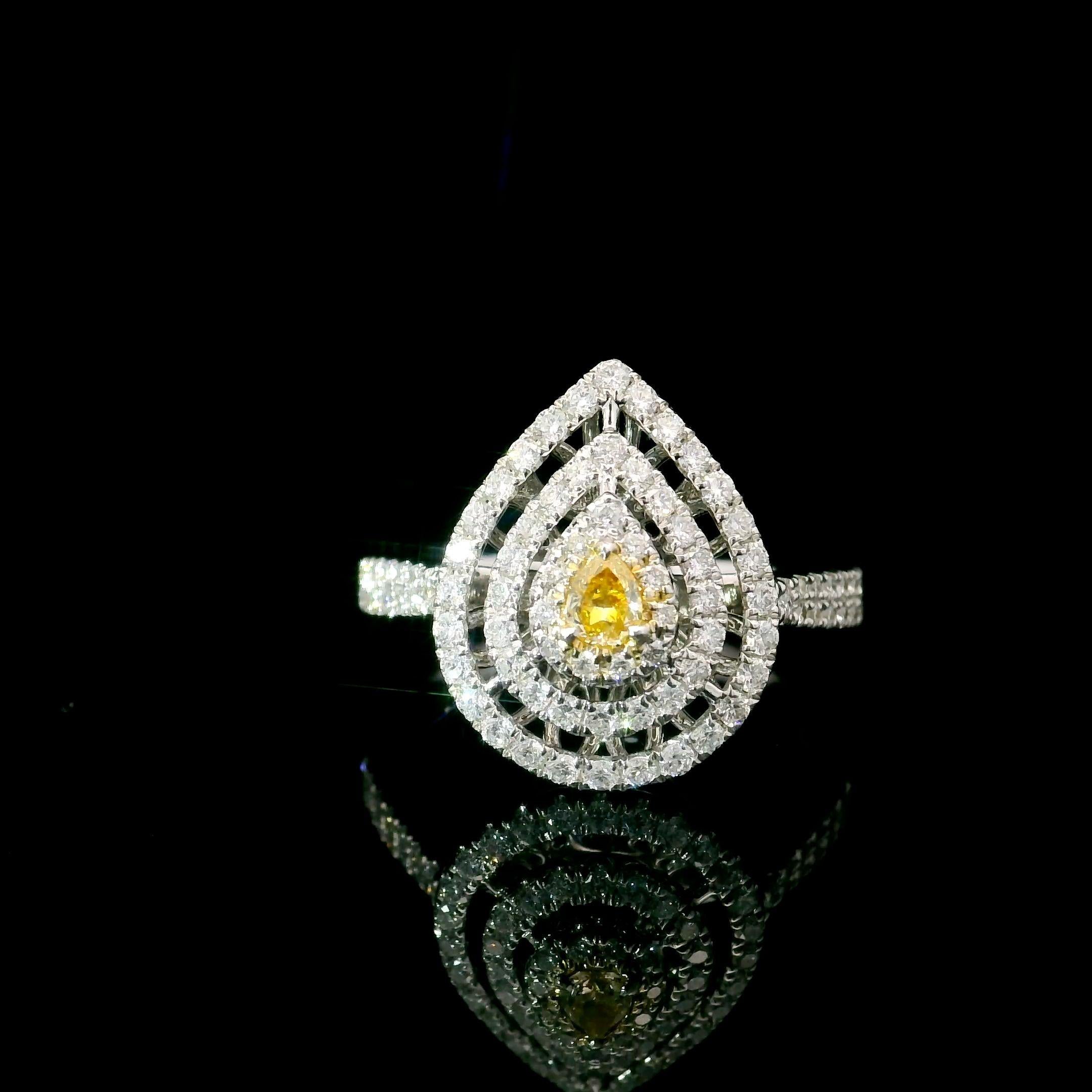 18kt white gold ring with diamonds
  
  Gold colour & karat: White gold 18kt
  Weight: 3.91 grams
  
  Set with-
  Stone type: Diamonds
  Shape: Pear
  Carat: 0.08 ct
  Colour: Fancy Yellow
  Clarity: VS
  
  Surrounding Stones: Diamonds
 1) White