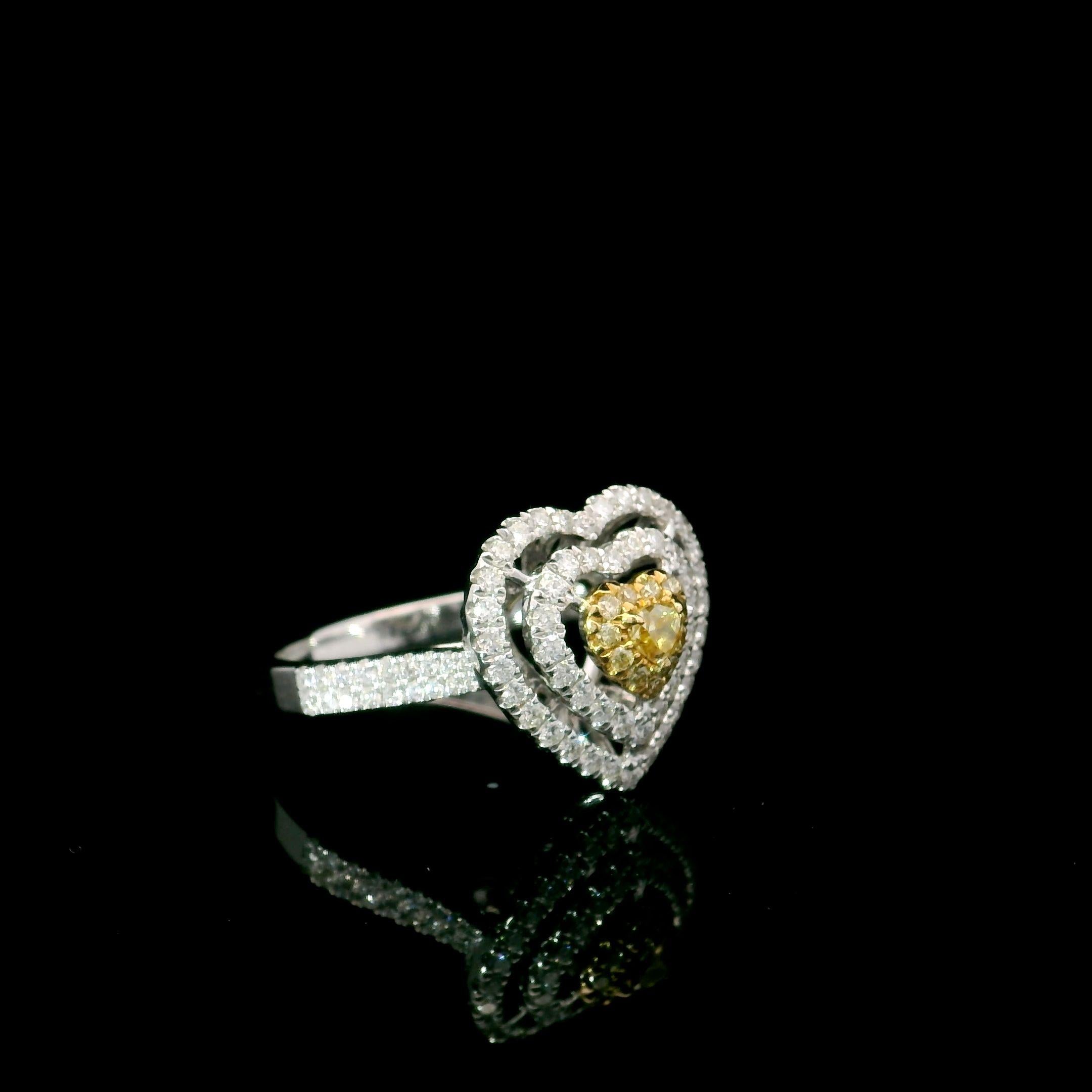 18kt white gold ring with diamonds
  
  Gold colour & karat: White gold 18kt
  Weight: 4.28 grams
  
  Set with-
  Stone type: Diamonds
  Shape: Heart
  Carat: 0.098 ct
  Colour: Fancy Yellow
  Clarity: VS
  
  Surrounding Stones: Diamonds
 1) White