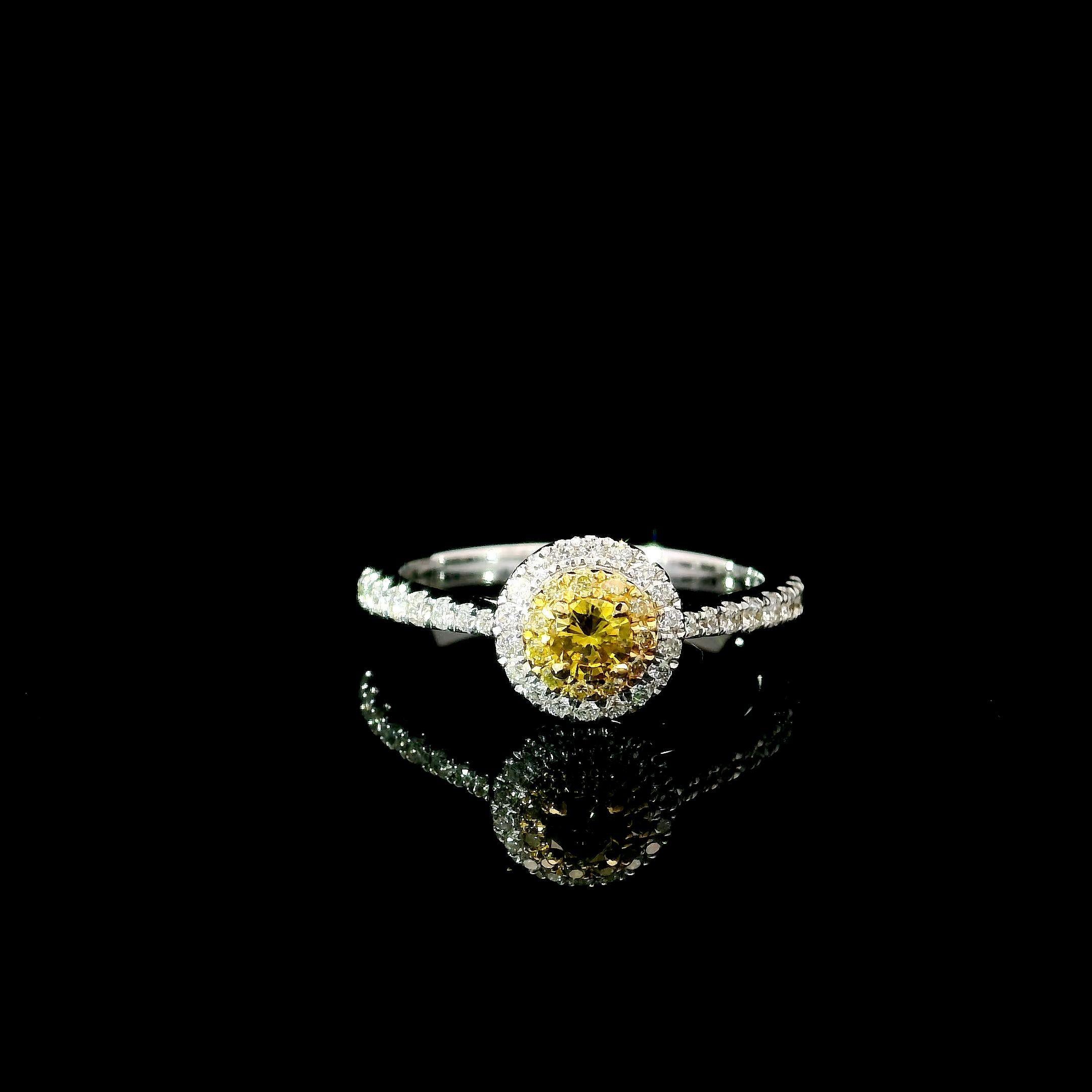 18kt white gold ring with diamonds
  
  Gold colour & karat: White gold 18kt
  Weight: 2.49 grams
  
  Set with-
  Stone type: Diamonds
  Shape: Round Brilliant
  Carat: 0.11 ct
  Colour: Fancy Intense Yellow
  Clarity: VS
  
  Surrounding Stones: